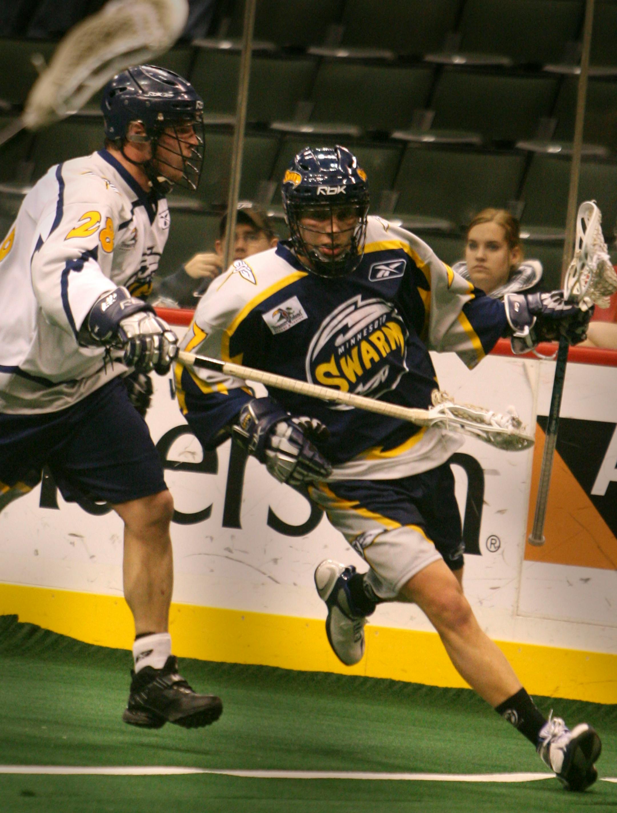 Minnesota Swarm forward Colin Achenbach, right, of Burnsville, MN, takes the ball downfield against teammate Darren Halls (28) during a Swarm open house and team scrimmage at the Xcel Energy Center.