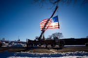 A firetruck hanging the American flag sits outside Burnsville City Hall the day two police officers and a first responder were killed at 12605 33rd Av