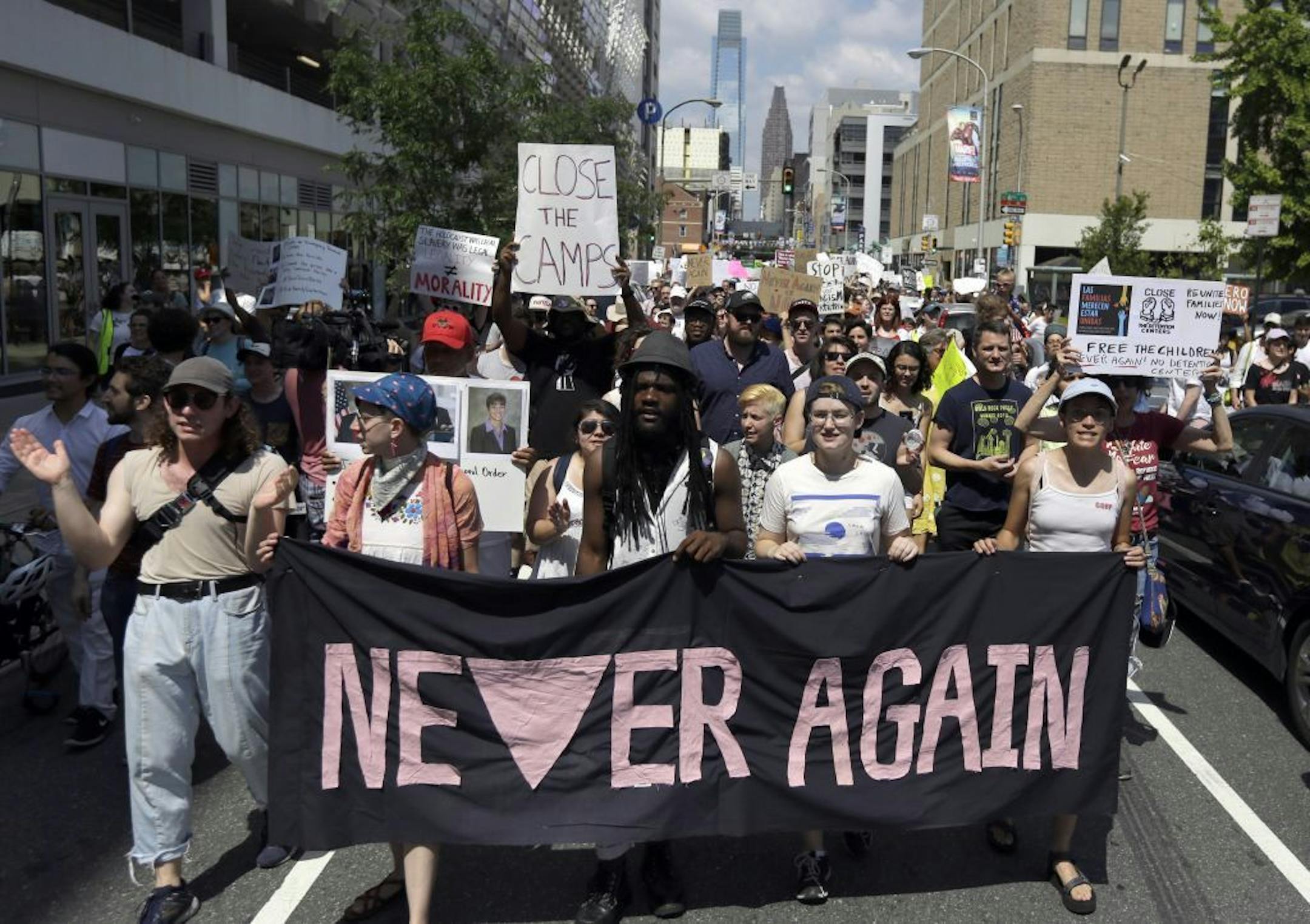 Protestors assembled by a majority Jewish group called "Never Again Is Now" walk through traffic as they make their way to Independence Mall Thursday July 4, 2019, in Philadelphia. Hundreds gathered during the city's traditional Fourth of July parade to protest the treatment of immigrants and asylum seekers.