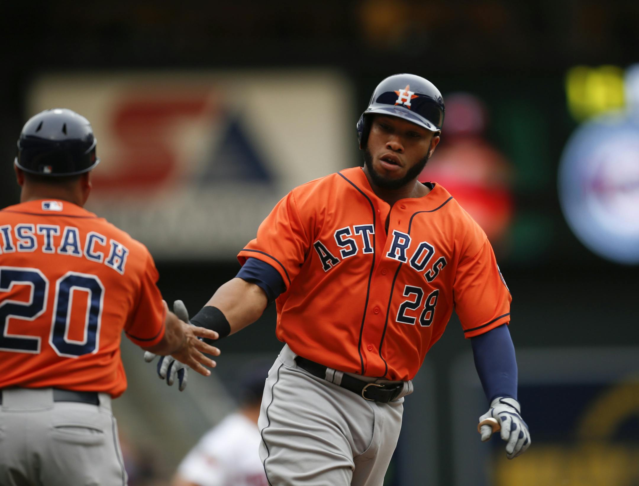 The Astros' Jon Singleton was congratulated by third base coah Pat Listach as he rounded the bases after his ninth inning grand slam Sunday afternoon at Target Field. ] JEFF WHEELER ‚Ä¢ jeff.wheeler@startribune.com The Twins lost 14-5 to the Houston Astros Sunday afternoon, June 8, 2014 at Target Field in Minneapolis.