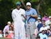Jordan Spieth and his caddie, Michael Greller, talk about his shot on the 7th green during the third round of the Masters at Augusta National Golf Clu