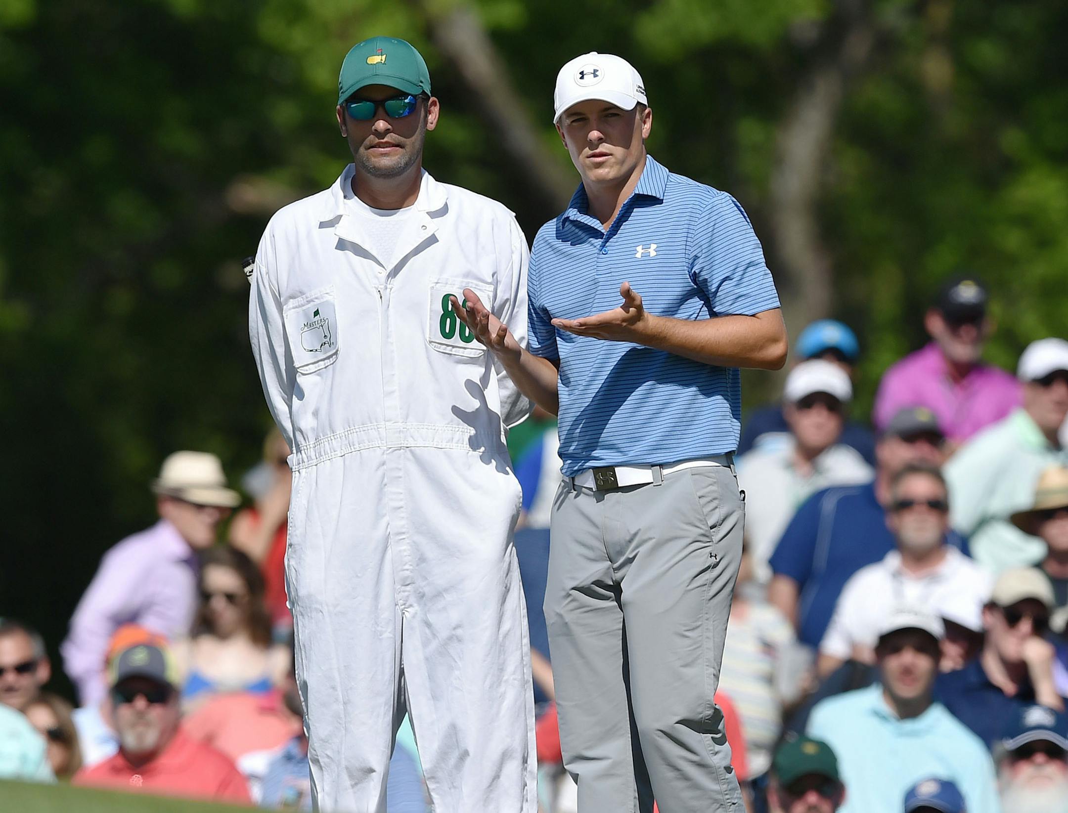 Jordan Spieth and his caddie, Michael Greller, talk about his shot on the 7th green during the third round of the Masters at Augusta National Golf Club on Saturday, April 11, 2015, in Augusta, Ga. (Brant Sanderlin/Atlanta Journal-Constitution/TNS)