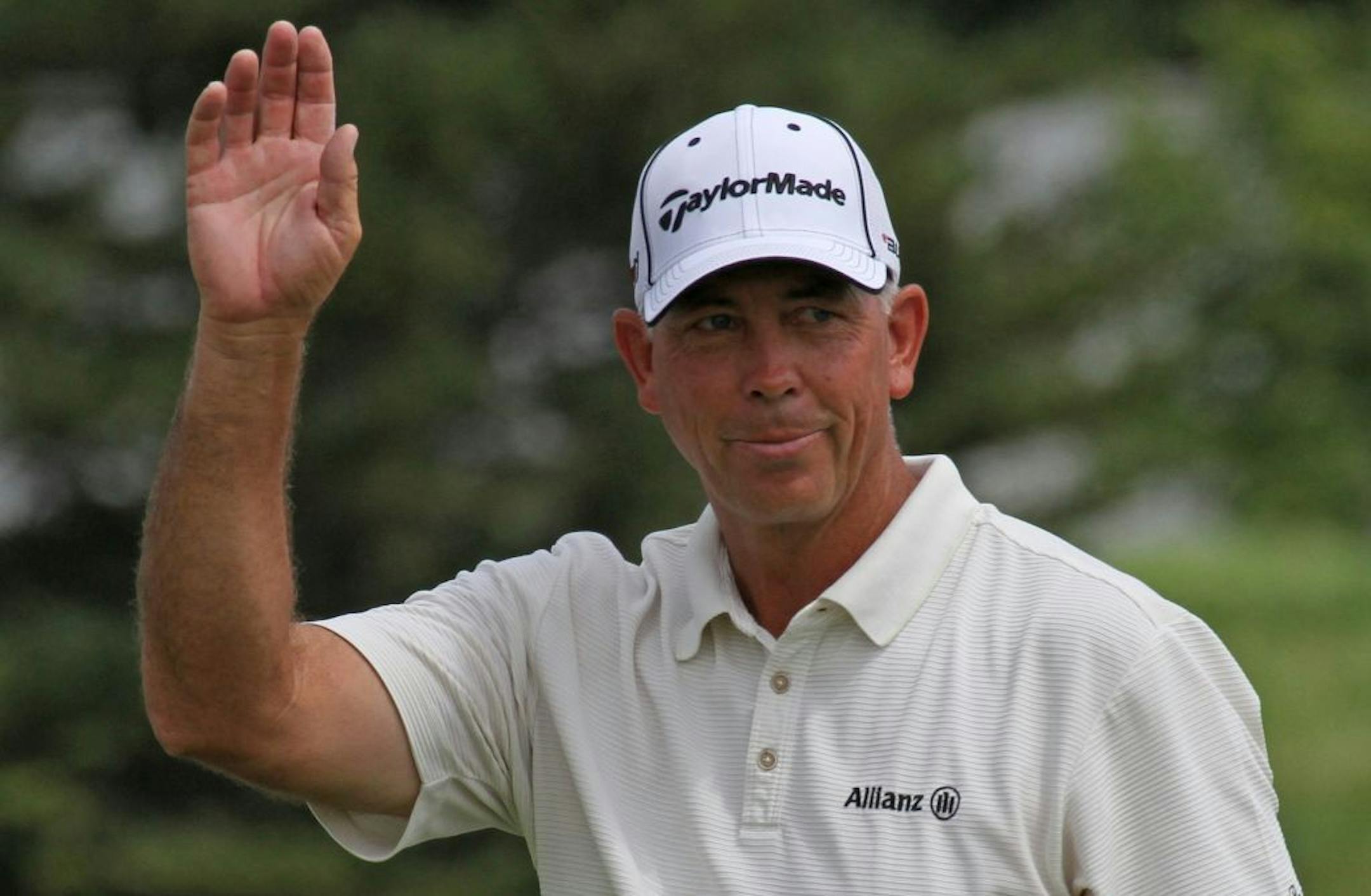 (center) Pro Golfer Tom Lehman waved to the gallery before starting the 3M Championship, Friday, August 5th, 2011 in Blaine MN.