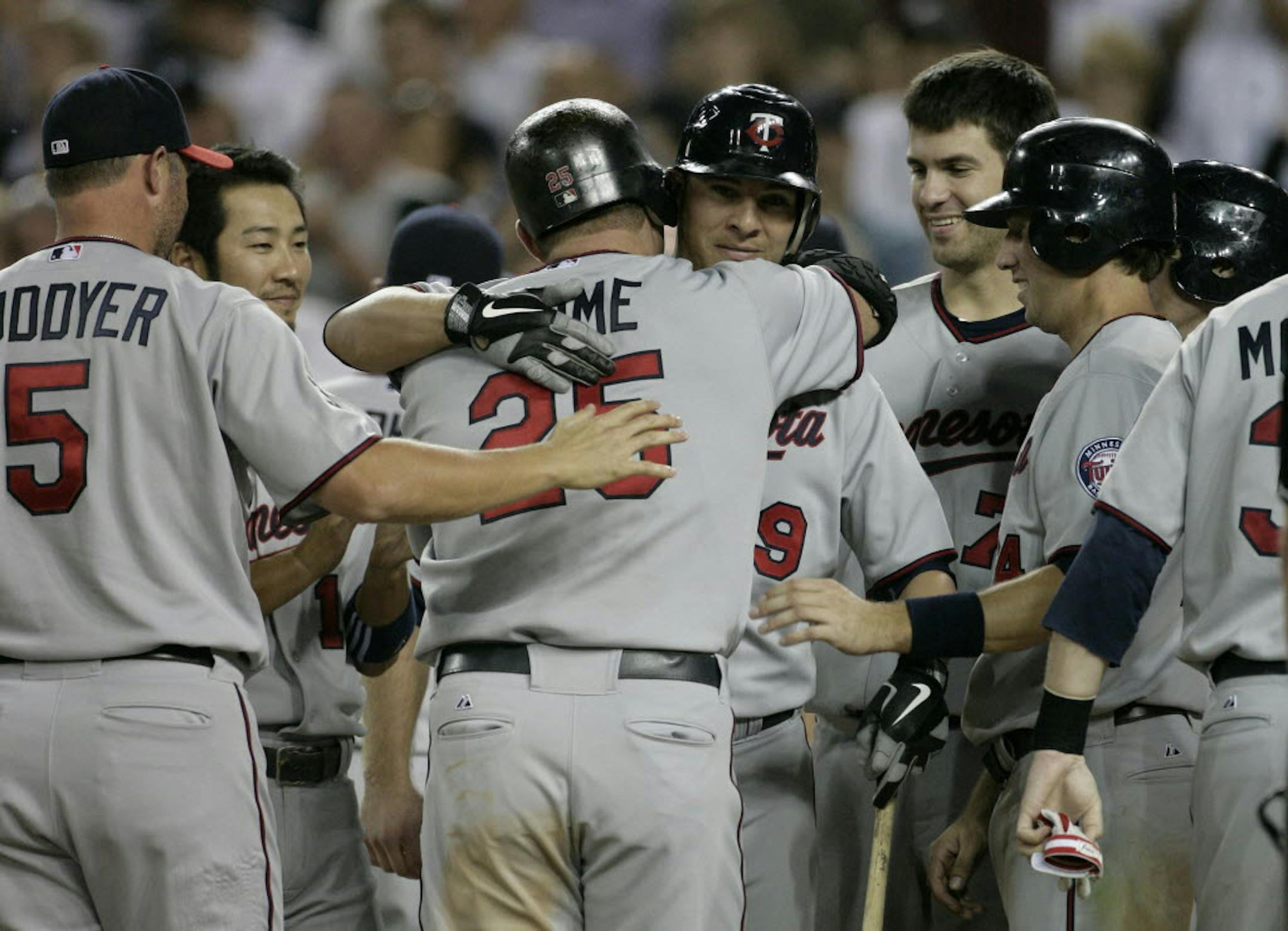 Twins designated hitter Jim Thome (25) hugged Danny Valencia as the Twins celebrated Thome's 600th career home run Monday.