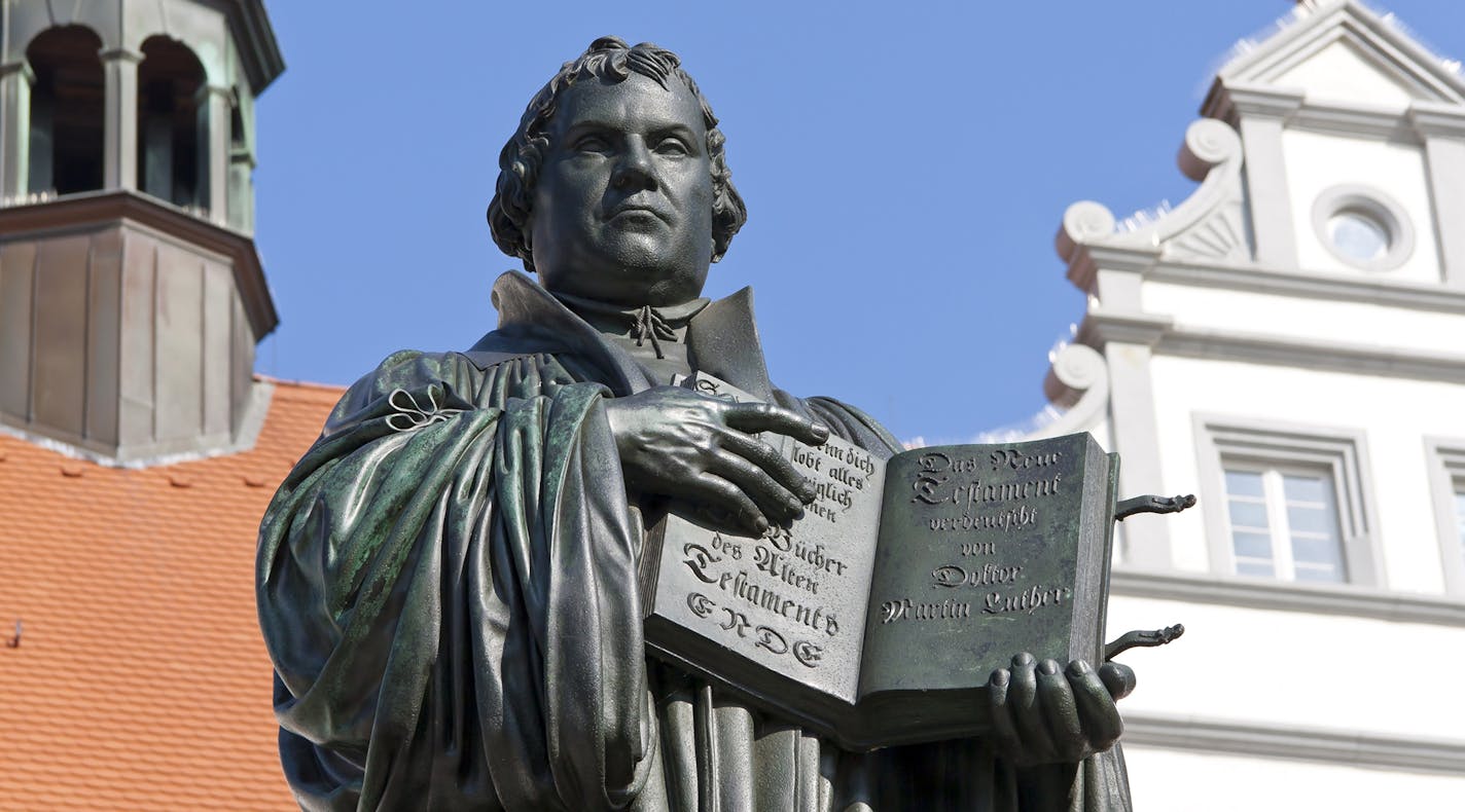 Monument of Martin Luther in Wittenberg, Germany. It was the first public monument of the great reformer, designed 1821 by Johann Gottfried Schadow. Martin Luther (1483-1546) was a German monk, theologian, and church reformer and the translator of the bible into German. He is also considered to be the founder of Protestantism. He lived and worked many years in Wittenberg.