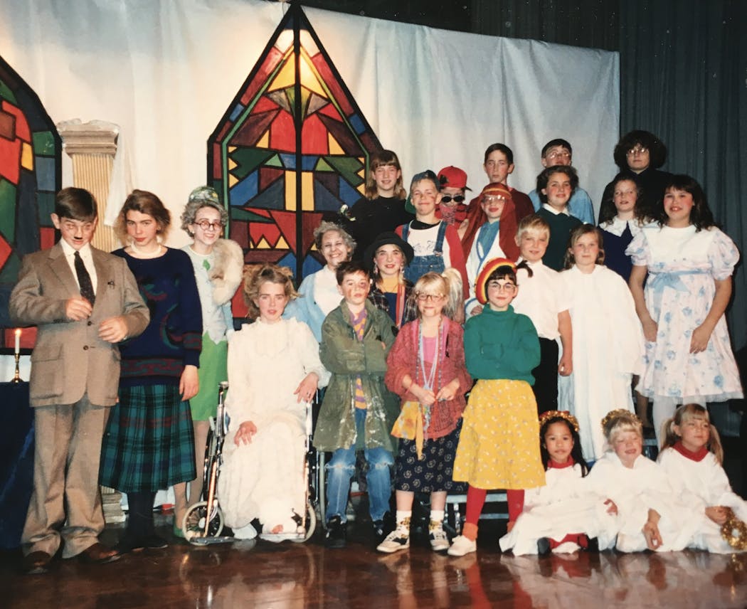 A cast photo of “The Best Christmas Pageant Ever” in 1993. “I was a freshman in high school,” recalled Rasmussen, pictured second from left, next to her brother Paul. “I co-directed this show with my two best friends, Ailsa Staub next to me, and Hannah Staub in the chair. My brother Carl is in the overalls midcenter. We performed in the basement and then took this show on tour to the middle school.”