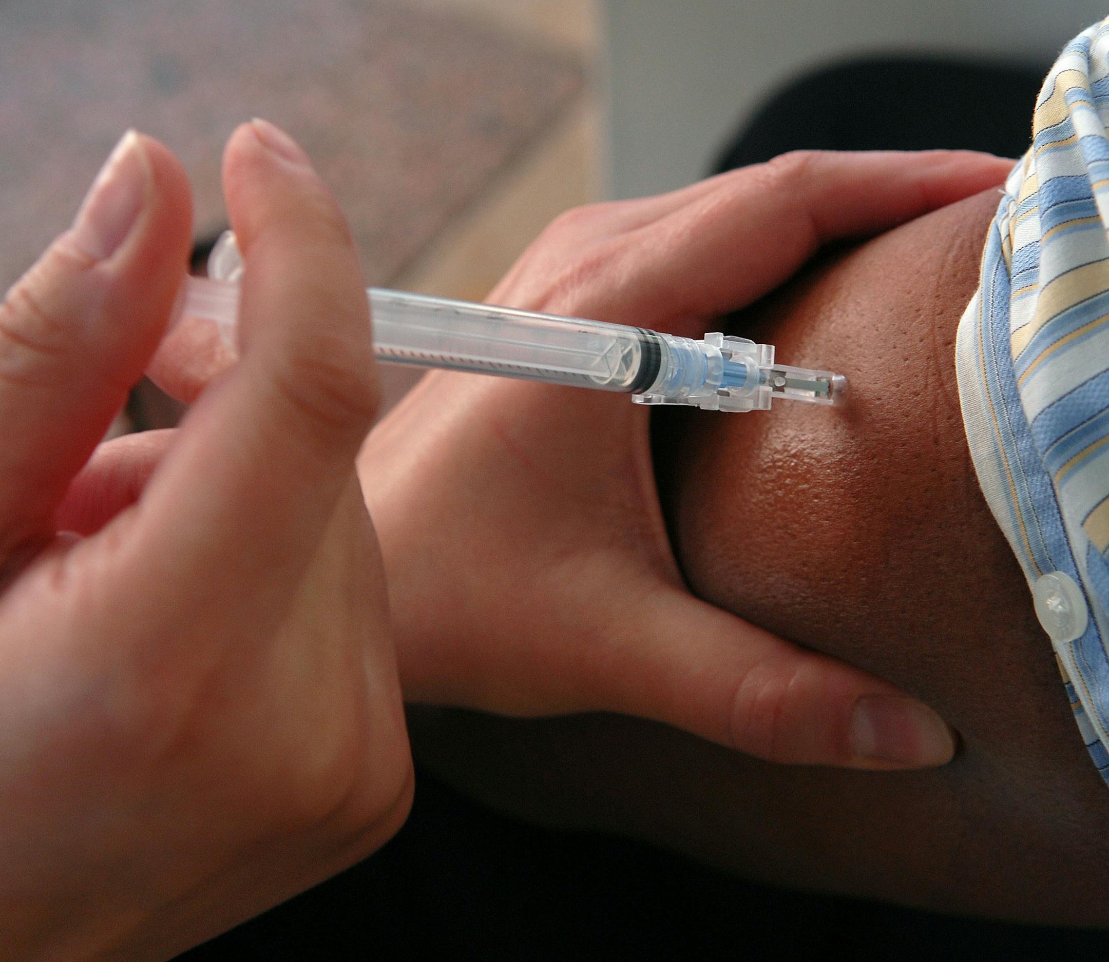 Richard Sennottïrsennott@startribune.com] The University of Minnesota's Boynton Health Service tries to set a Guinness World Redord for the most flu shots given in a single day. In this picture: Amelious Whyte of Minneapolis, Mn. who is with The U of M got his flu shot ORG XMIT: MIN2013091017503405