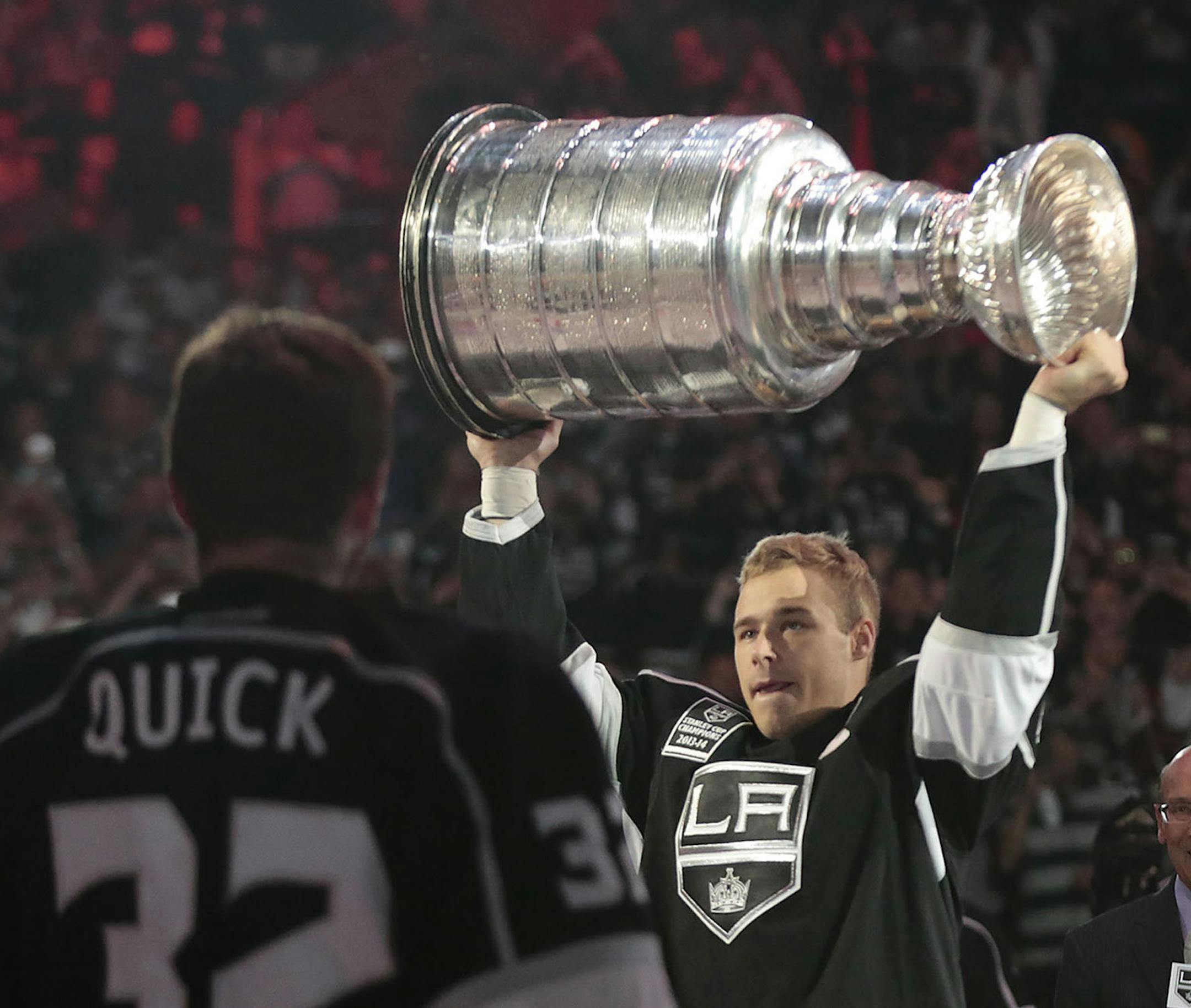 Los Angeles Kings captain Dustin Brown raises the Stanley Cup during the team's NHL Championship banner ceremony before action against the San Jose Sharks at Staples Center in Los Angeles on Wednesday, Oct. 8, 2014. (Robert Gauthier/Los Angeles Times/MCT)