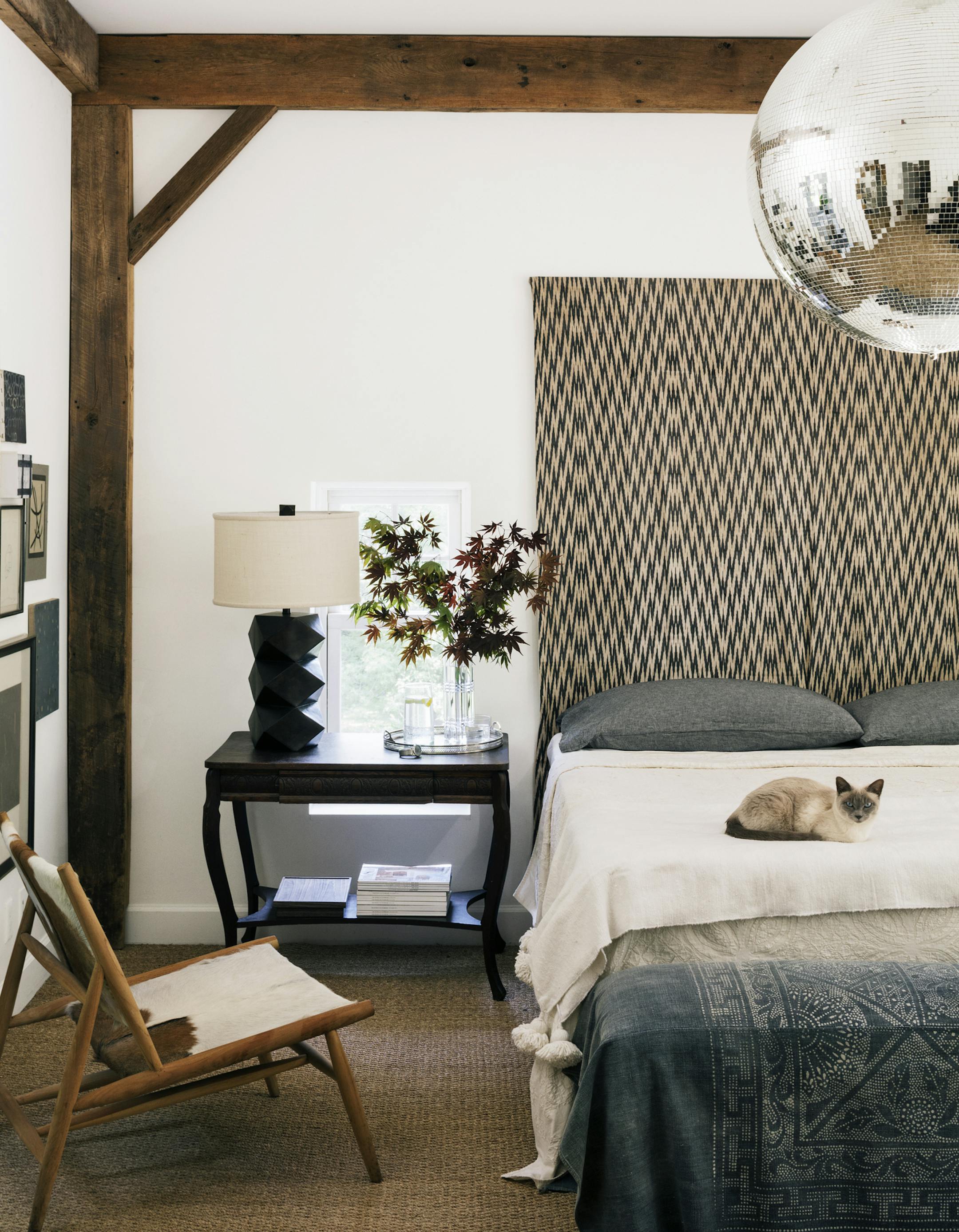 Create backdrops: Walls painted in warm neutrals (like Farrow & Ball's Wimborne White) show off striking pieces, such as the antique ikat textile Scheeler uses as a headboard.
