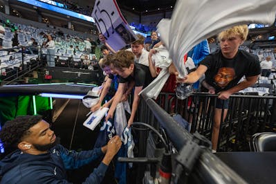Timberwolves fans seek autographs from center Karl-Anthony Towns during pre-game warmups before Game 5 in the NBA's Western Conference finals at Targe