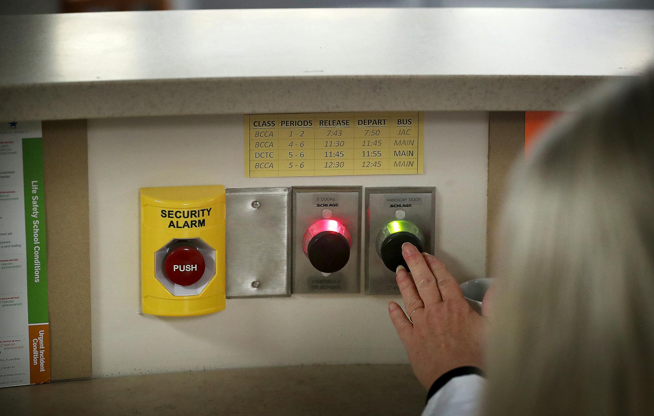 Bloomington Jefferson High School, in response to past mass shootings, has redesigned an renovated the entrance to the high school to protect students and staff in the case of an event. Here, the front entrance security hall monitor, who wished not to be identified, presses a remote lock release to allow tardy students into the school's front entry doors Wednesday, Feb. 21, 2018, in Bloomington, MN.] DAVID JOLES &#xef; david.joles@startribune.com In the wake of the school shooting in Florida tha