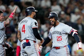 The Twins' Byron Buxton (25) greets teammates Jose Miranda, left, and Carlos Correa after the three of them scored on Buxton's second three-run homer 