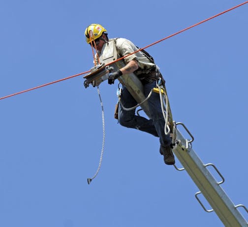 This lineman was delivered to the 150 tower by helicopter.Xcel Energy is installing a new power line along I-94 between Monticello and St. Cloud.On Thursday August 25 2011 in Clearwater, Minn. Harnessed workers hanging from helicopters weree doing some of the high-wire work, which consists of stringing transmission conductor lines and other hardware from pole to pole. It's part of the first major upgrade of high voltage power lines in the state in 30 years.