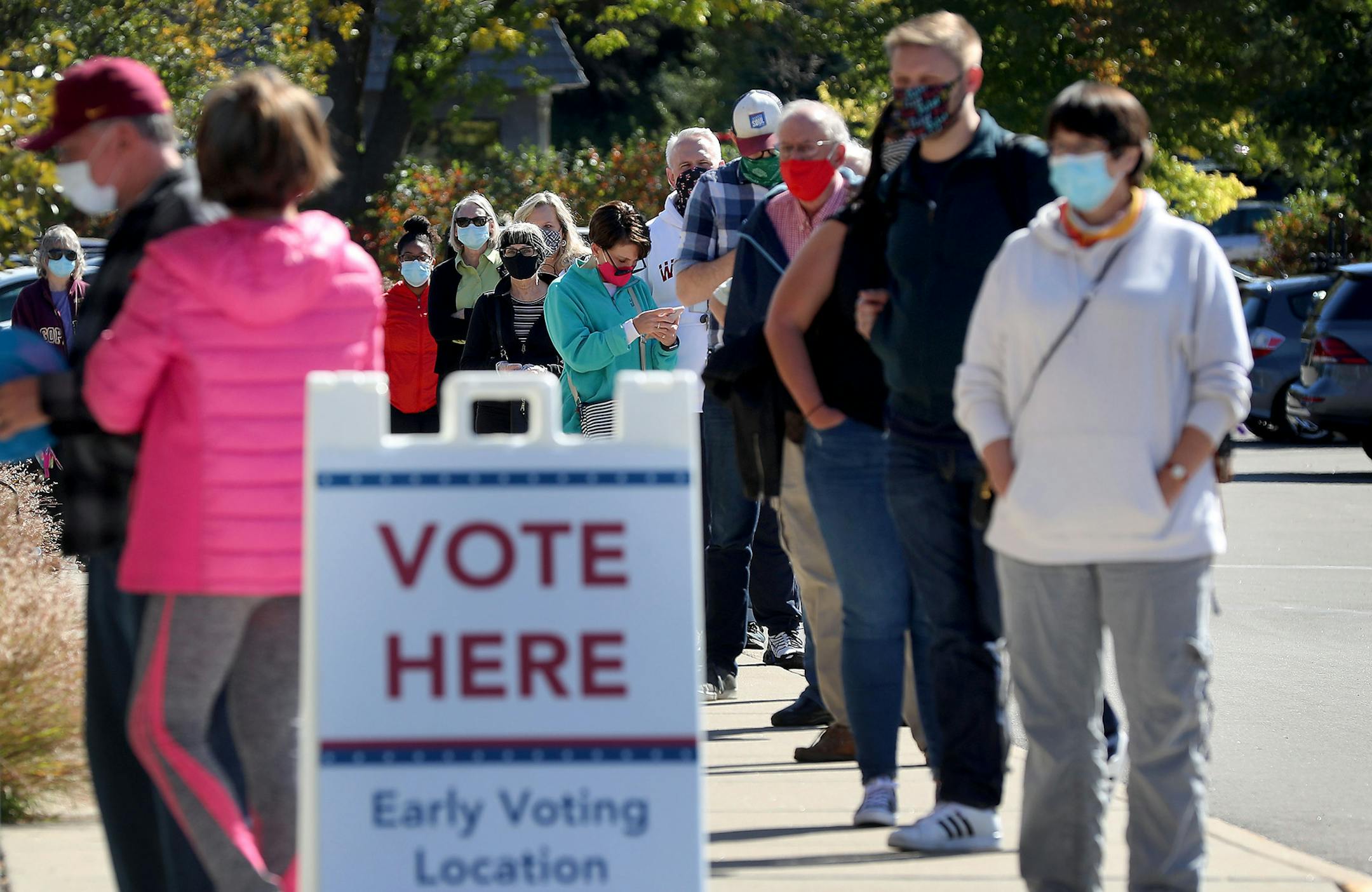 A long line of voters waited to cast their ballots during early voting at Ramsey County Library Friday in Roseville. ] DAVID JOLES • david.joles@startribune.com Friday, Sept. 18, 2020, in Minneapolis, MN. Early voting in Minneapolis on first day of voting Friday.**Jack O'Rourke, Jason Miller, Simone Frierson, Nick Stumo-Langer, cq