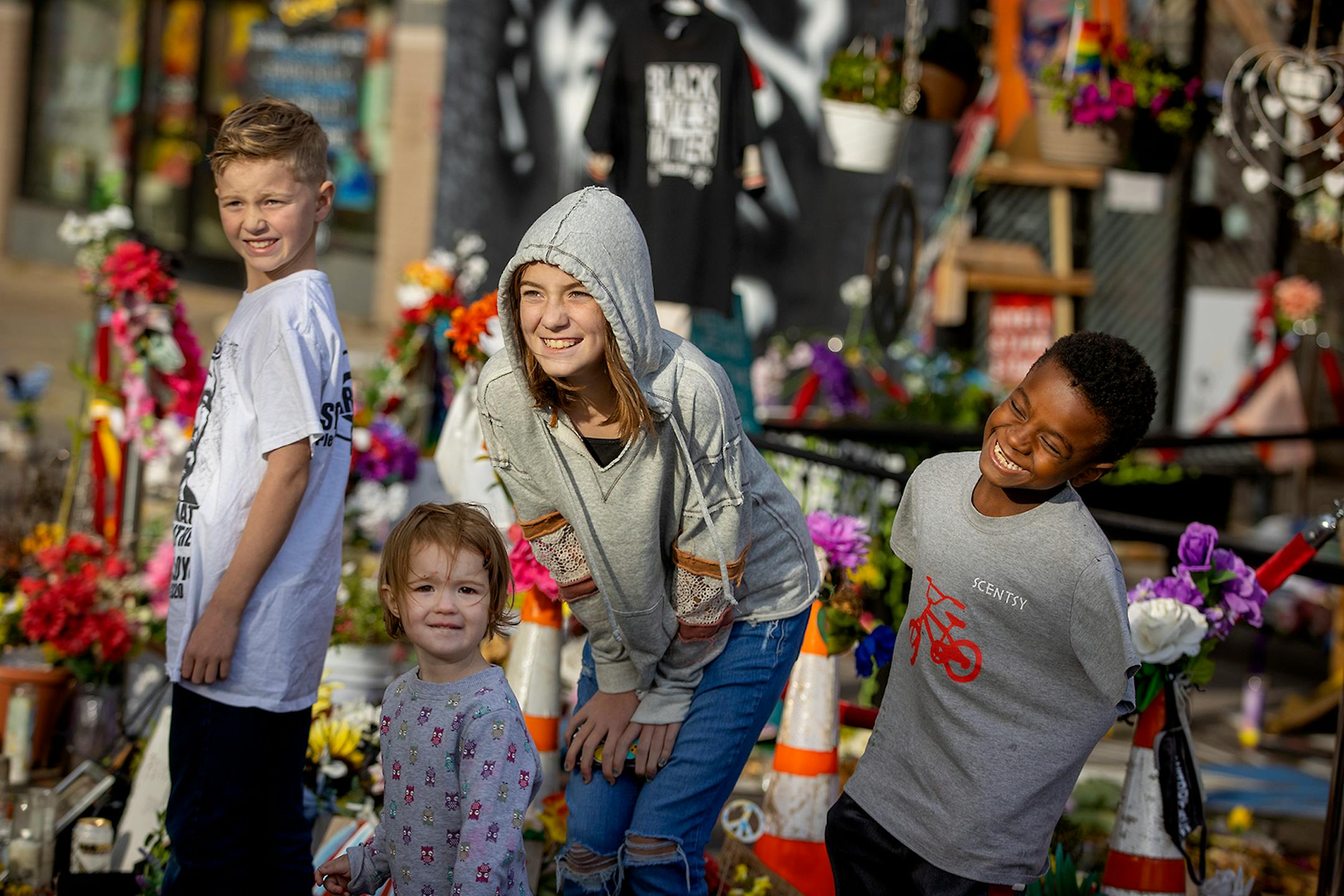 Kate Lundquist documented as she and her family, including from left, Ridge, 9, Verabeth, 2, Charlotte, 11, and Maki, 8, made a visit to the the George Floyd memorial at 38th and Chicago Avenue South, Wednesday, September 30, 2020 in Minneapolis, MN.