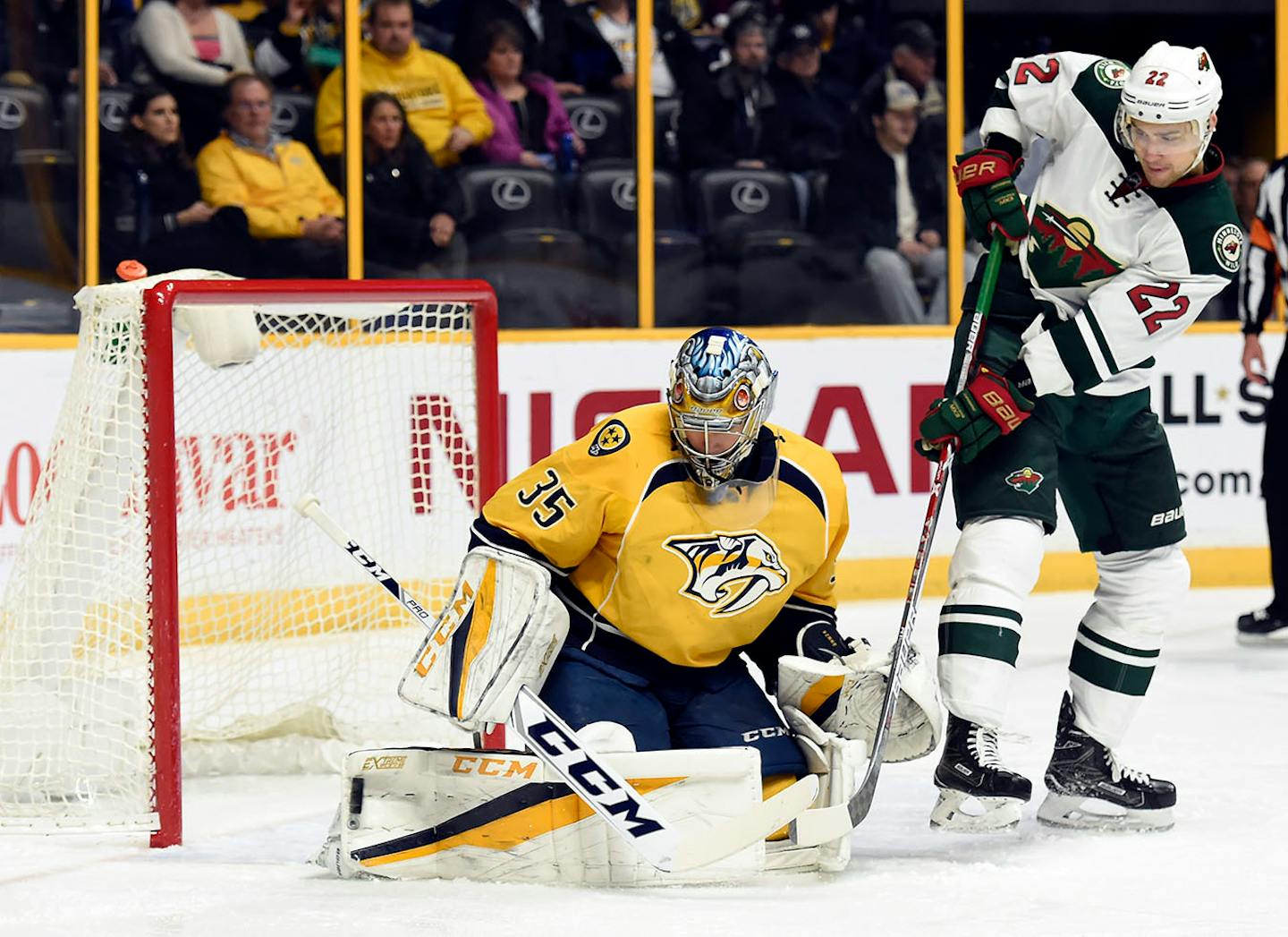 Nashville Predators goalie Pekka Rinne (35), of Finland, blocks a shot as Minnesota Wild right wing Nino Niederreiter (22), of Switzerland, looks for the rebound during the first period of an NHL hockey game Tuesday, Dec. 27, 2016, in Nashville, Tenn.