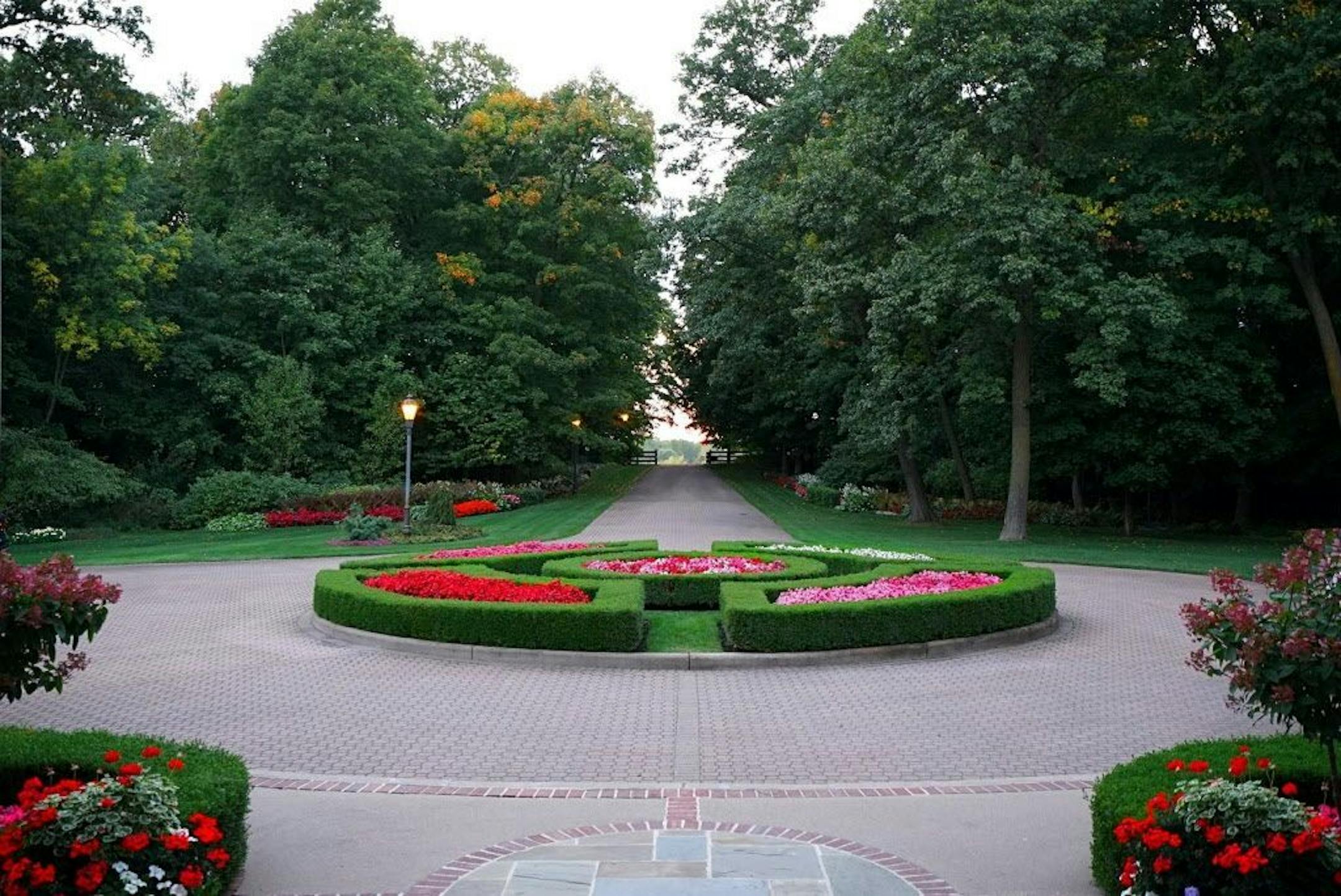 Front entry courtyard landscaped with formal English-style gardens.