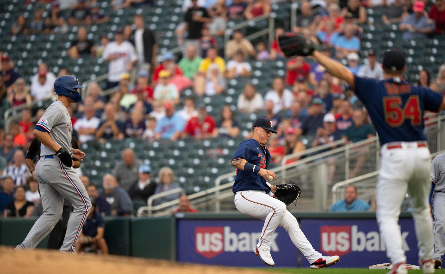 Twins first baseman Jose Miranda reached for first baseman to force out Texas Rangers shortstop Corey Seager (5) for the second out of a triple play in the fourth inning Monday night, August 22, 2022 at Target Field in Minneapolis, Minn. The Minnesota Twins faced the Texas Rangers in an MLB baseball game. ] JEFF WHEELER • Jeff.Wheeler@startribune.com