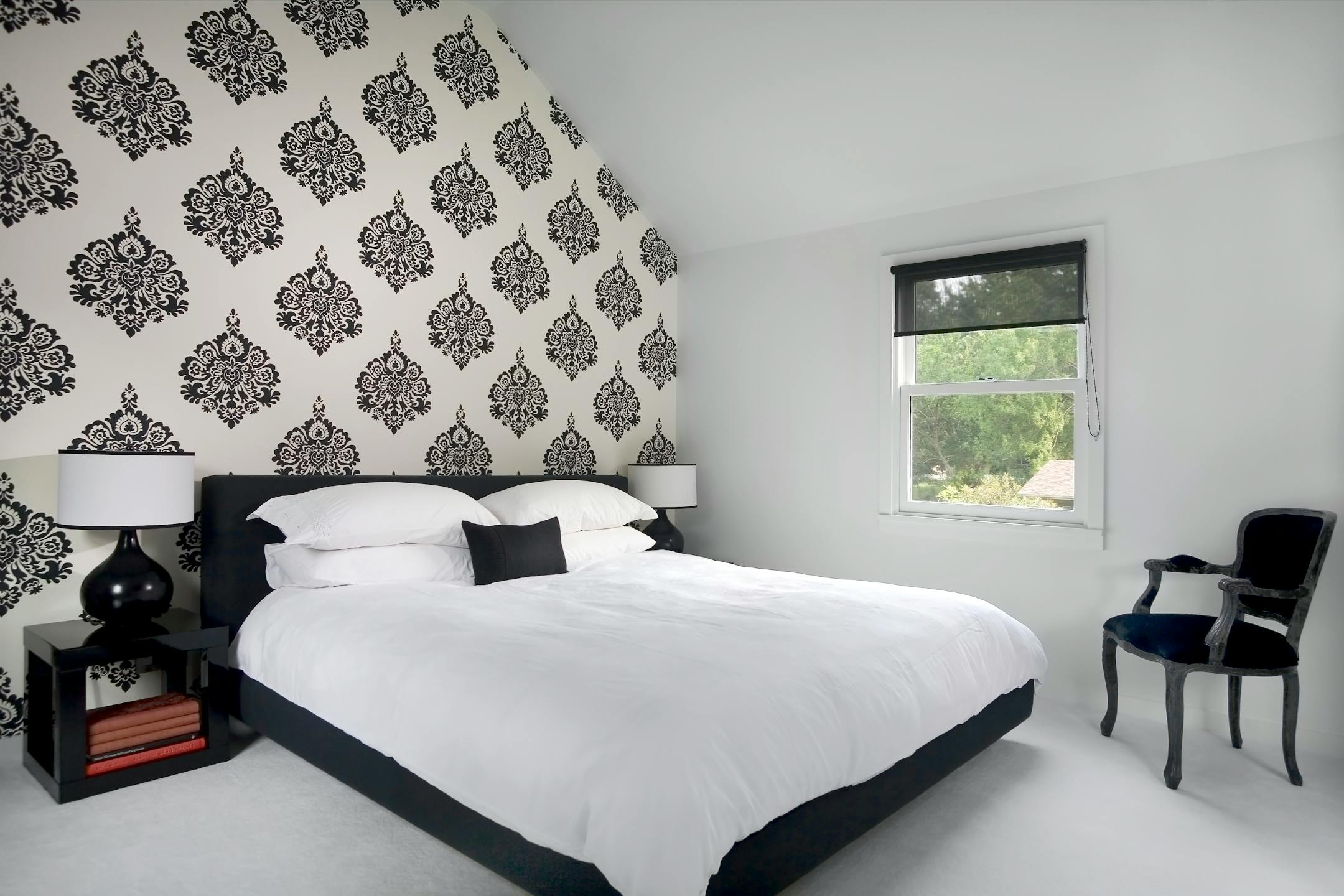 Black and white bedroom with patterned wallpaper