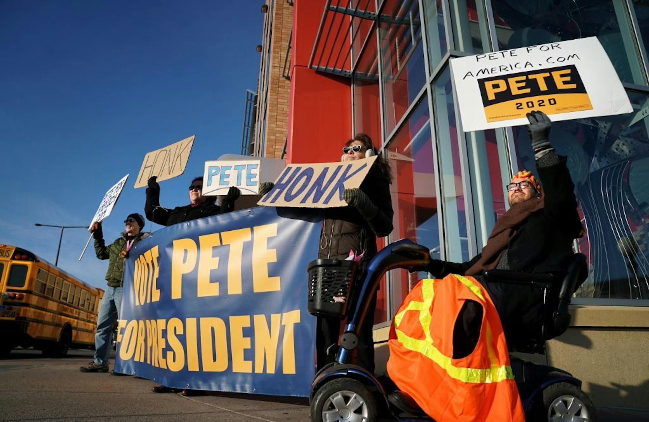 John Allen, Gloria Everson, Debbie Allen and Chris Beckstrom waved signs asking drivers to honk their horns for Pete Buttigieg for President Thursday in St. Paul, MN.
