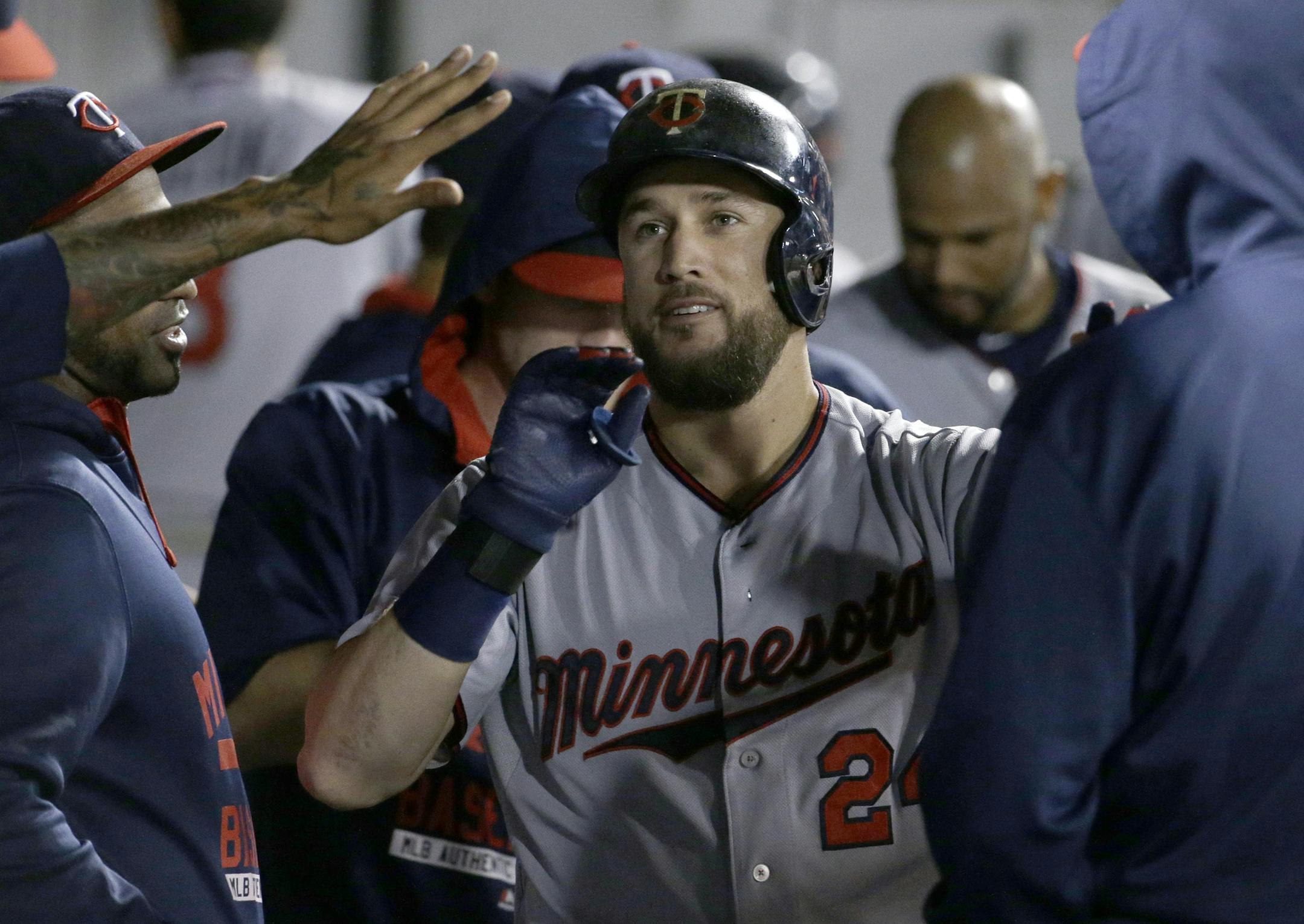 Minnesota Twins' Trevor Plouffe celebrates with teammates after hitting a solo home run against the Chicago White Sox during the eighth inning of a baseball game, Friday, Sept. 11, 2015, in Chicago. The Twins won 6-2. (AP Photo/Nam Y. Huh)