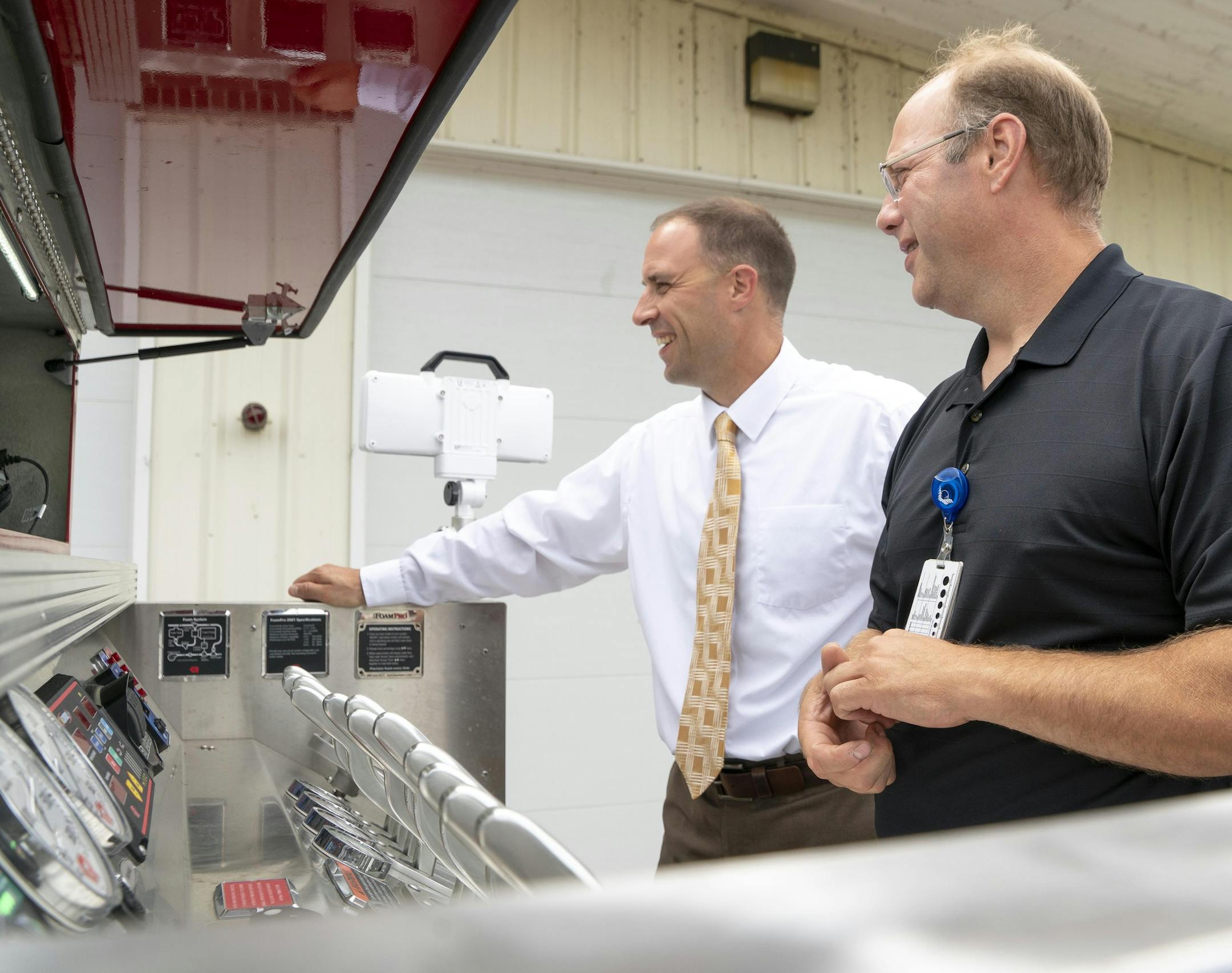 Sourcewell CEO Chad Coauette (left) and Staples Fire Chief Scott Brait inspect the Staples department's Rosenbauer two-door commercial pumper truck acquired in 2017 at an estimated savings of $10,000 through Sourcewells' cooperative procurement program. Photo: Sourcewell