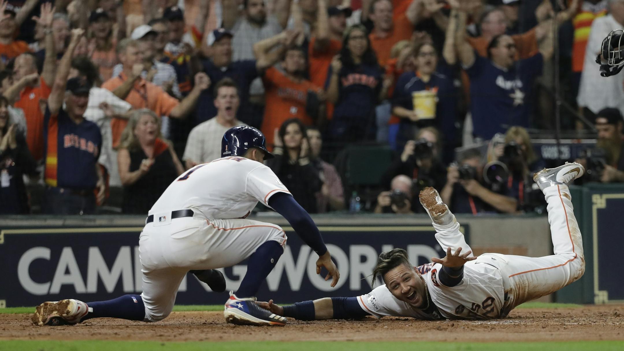 Houston Astros' Yuli Gurriel reacts as he scores during the fifth inning of Game 7 of baseball's American League Championship Series against the New York Yankees Saturday, Oct. 21, 2017, in Houston. (AP Photo/David J. Phillip)