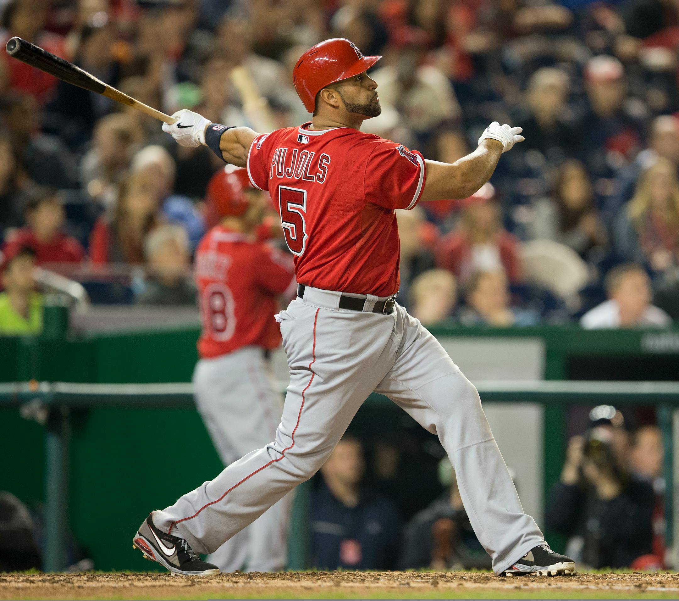 Los Angeles Angels Albert Pujols watches the ball after connecting for a two-run homer against Washington Nationals Taylor Jordan in the fifth inning of a baseball game in Washington, Tuesday, April 22, 2014. This was Pujols 500th career home run. (AP Photo/Pablo Martinez Monsivais)