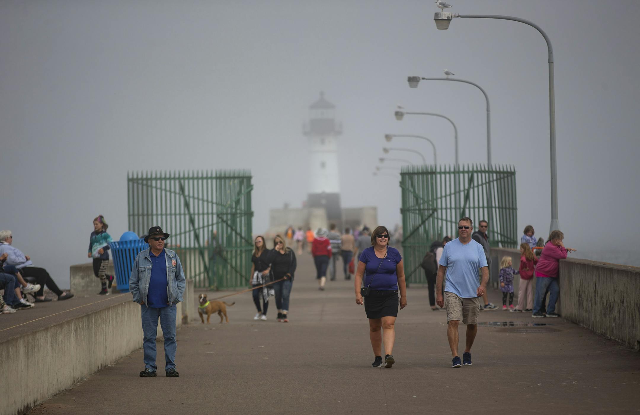Tourists and locals move through Canal Park in front of the Duluth Harbor North Pier Light on Monday September 16, 2019.]
ALEX KORMANN • alex.kormann@startribune.com
