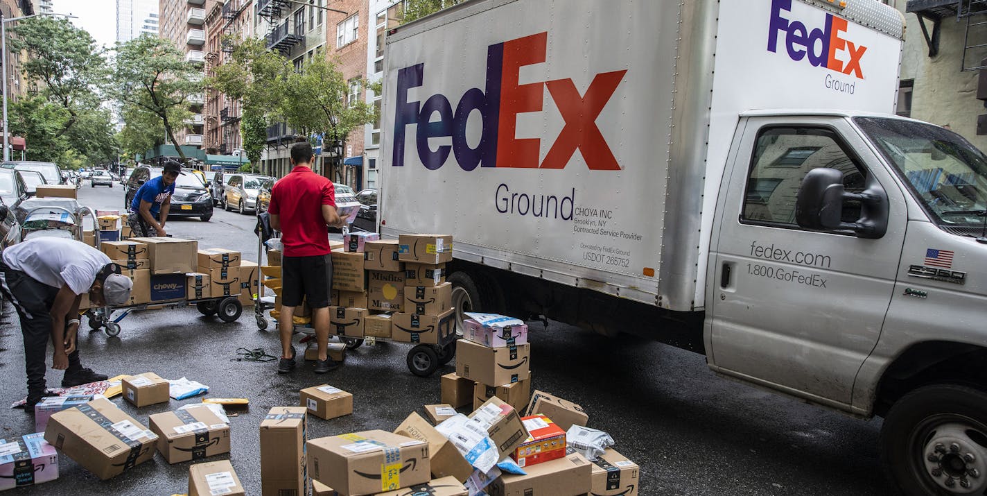 **EMBARGO: No electronic distribution, Web posting or street sales before Sunday at 3:01 a.m. ET, Nov. 17, 2019. No exceptions for any reasons. EMBARGO set by source.** FILE -- A FedEx truck drives around workers sorting packages on the Upper East Side of Manhattan, Aug. 28, 2019. In the 2017 fiscal year, FedEx owed more than $1.5 billion in taxes. The next year, after President Donald Trump's tax cut, it owed nothing. And like much of corporate America, the company has not made good on its prom