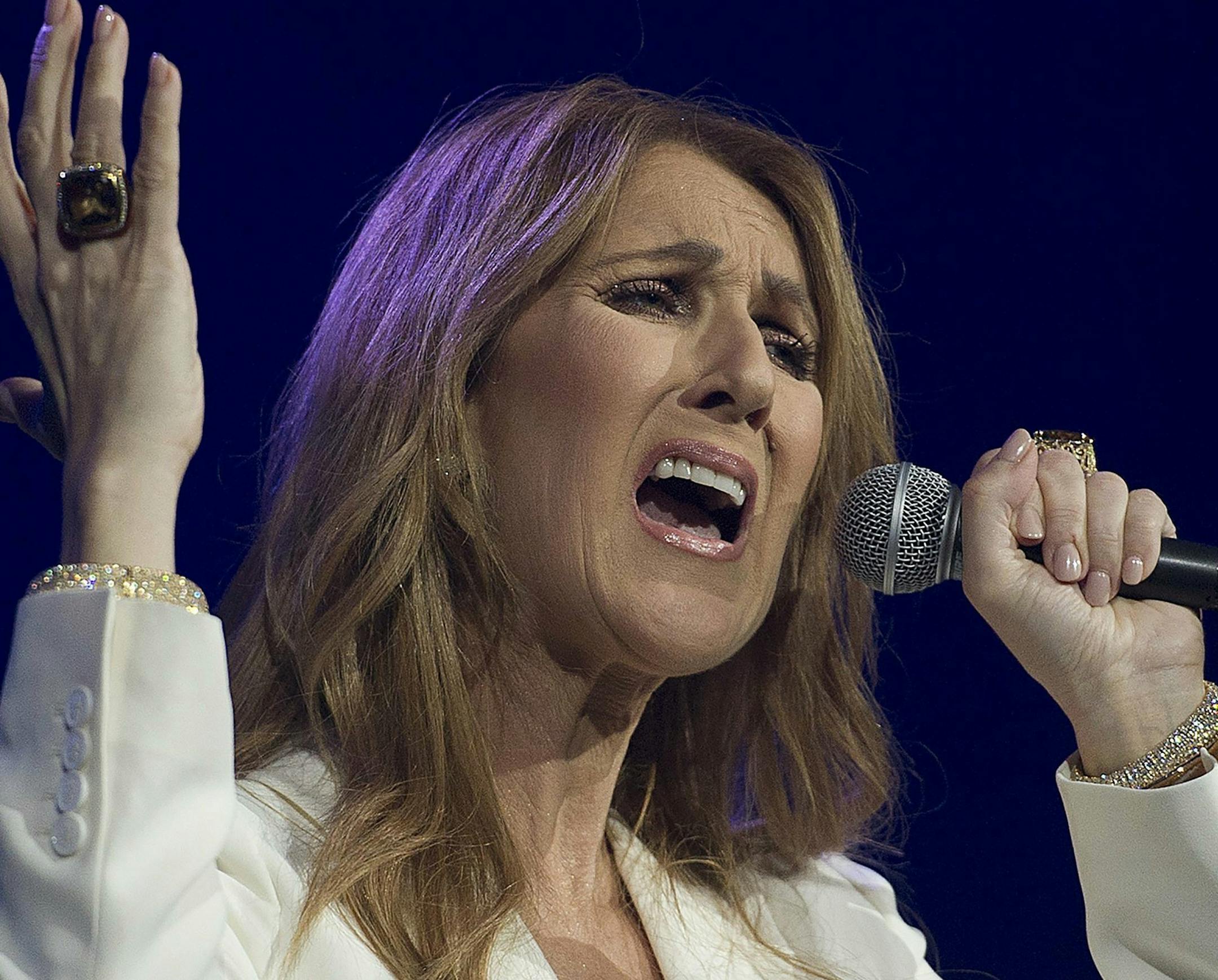 FILE - In this July 31, 2016 file photo, Celine Dion performs in concert at the Bell Centre in Montreal. In the wake of multiple allegations against R. Kelly, some performers are denouncing songs the R&B hitmaker created for them. Dion followed in Lady Gaga's footsteps, removing her Grammy-nominated duet with the embattled singer, R. Kelly, "I'm Your Angel," from streaming platforms. (Graham Hughes/The Canadian Press via AP, File)
