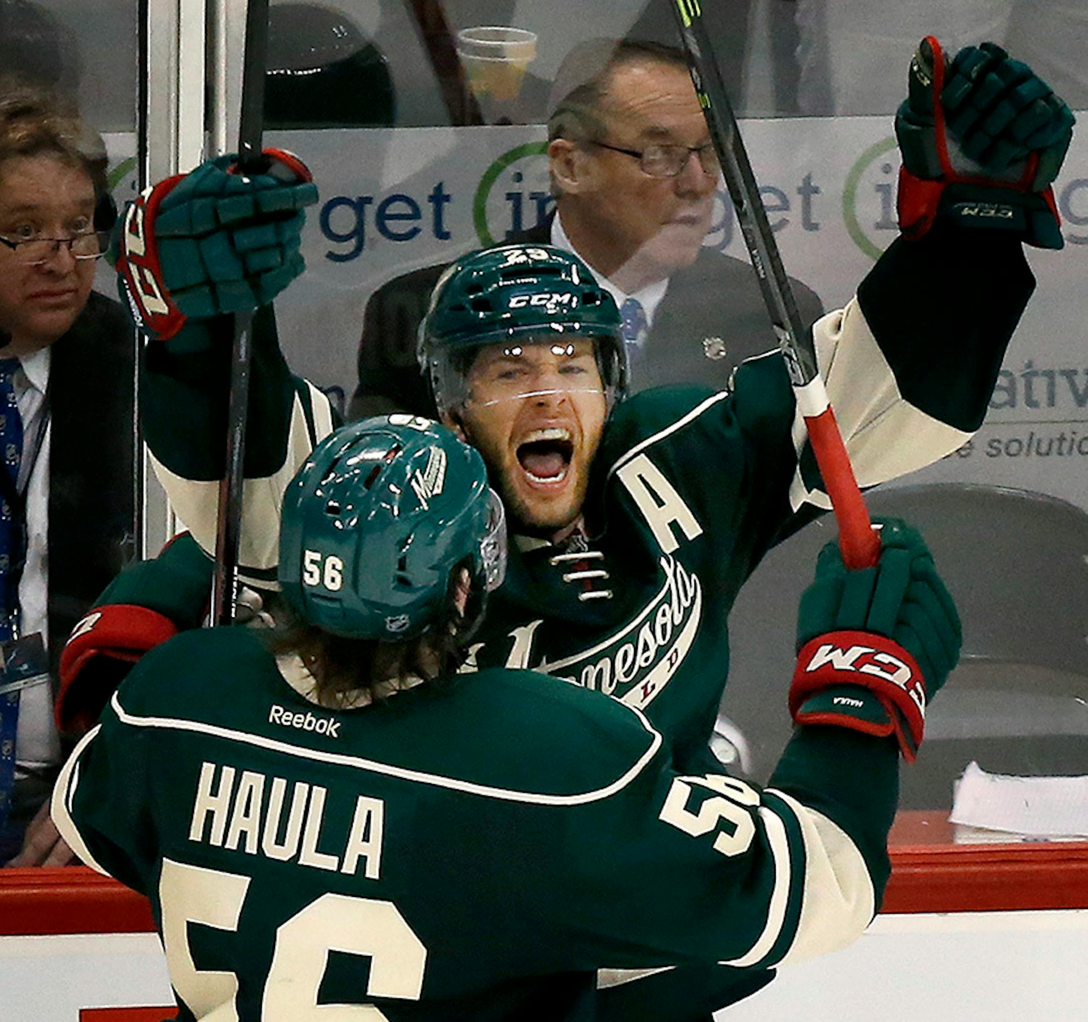 Jason Pominville and Erik Haula (56) celebrated an empty net goal by Pominville in the third period.