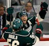 Jason Pominville and Erik Haula (56) celebrated an empty net goal by Pominville in the third period.