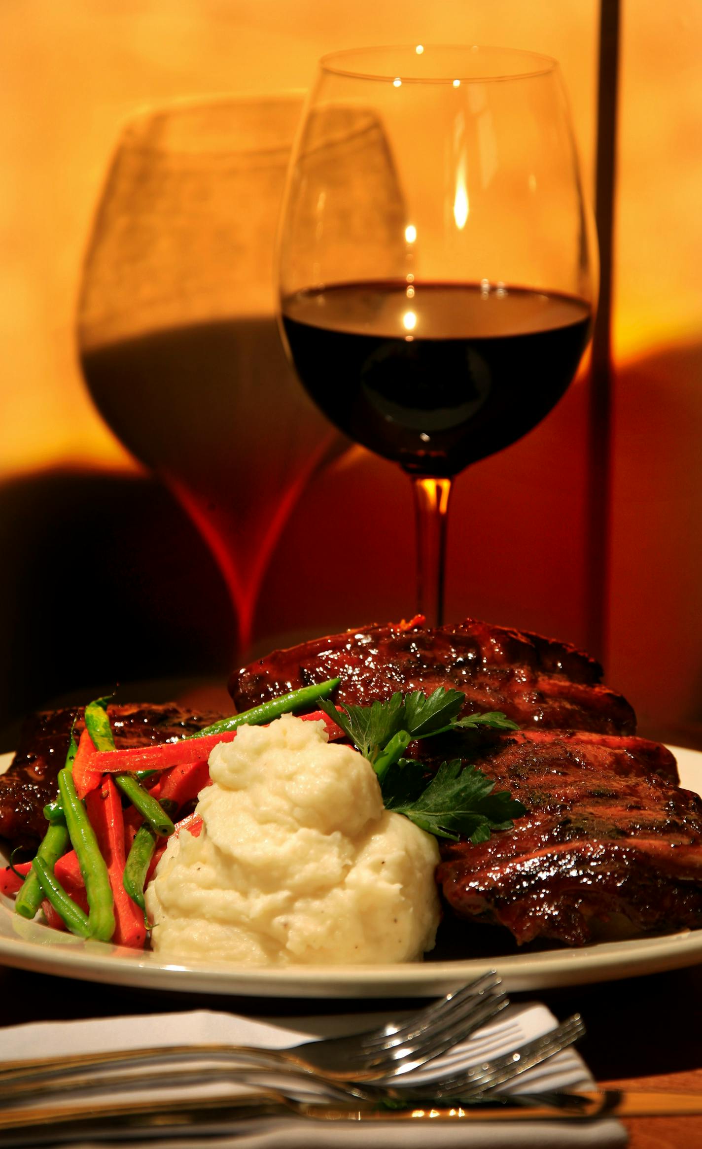 The coming through the window at the 128 Cafe warms the walls and highlights the BBQ baby back ribs with mashed potatoes and sauteed vegetables.