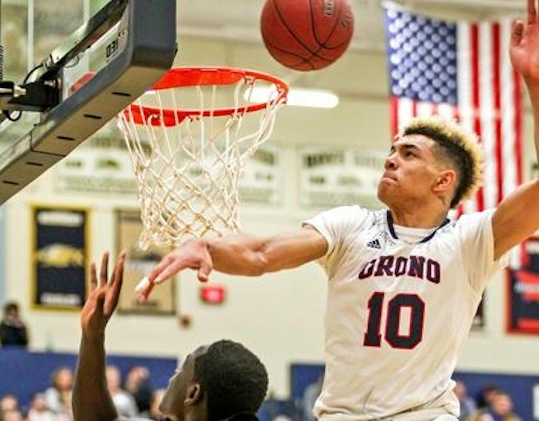 Orono's Jarvis Thomas (10) blocks a shot by De La Salle's Goanar Mar in the second half of the boys' basketball Class 3A Section 6 championship game at Chanhassen High School. Thomas scored 20 points (on scoreboard, check against boxscore) in Orono's 71-68 loss. Photo by Mark Hvidsten, SportsEngine