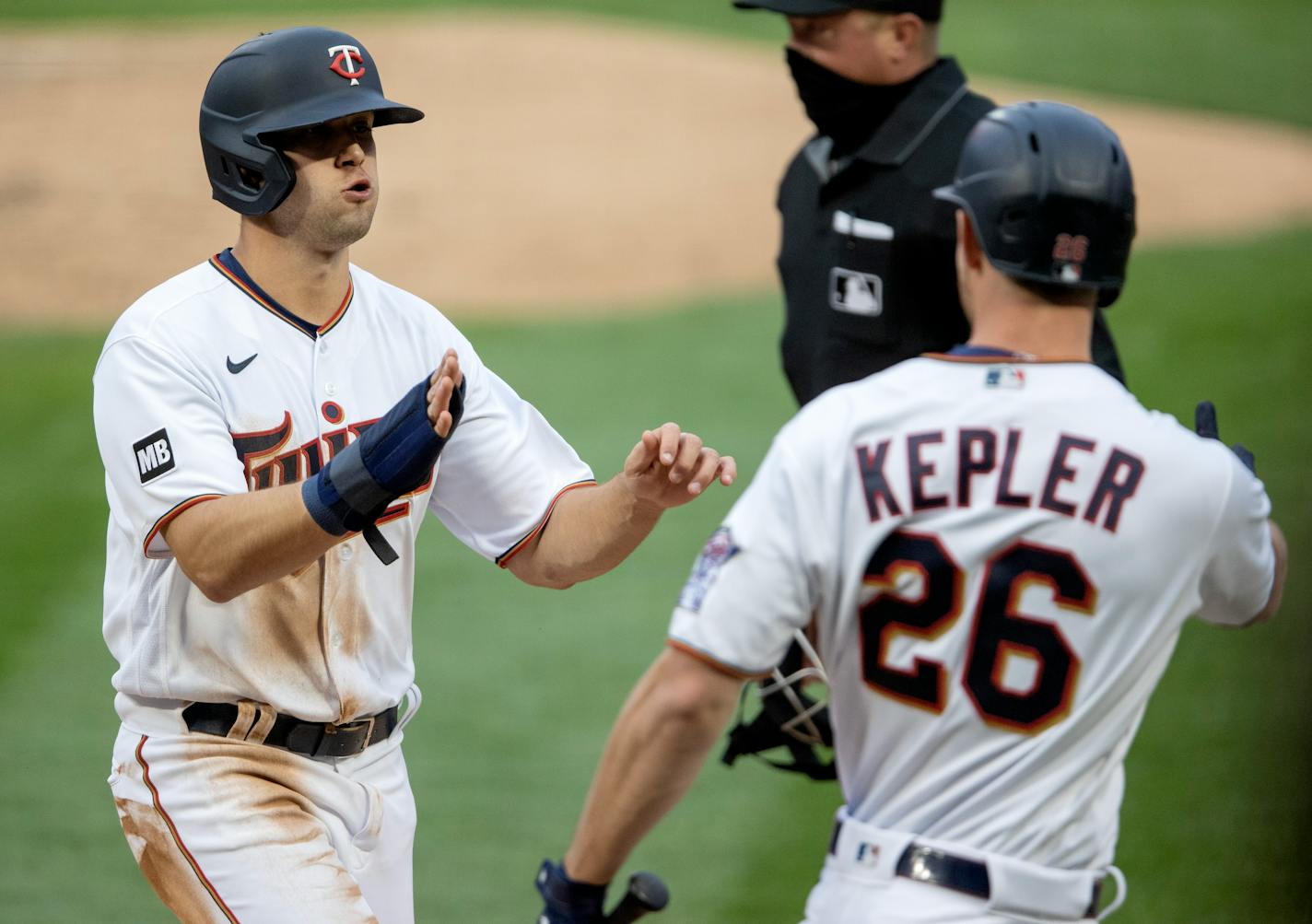 Alex Kirilloff (19) of the Minnesota Twins was greeted by Max Kepler (26) after scoring in the second inning.