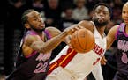 Minesota Timberwolves forward Andrew Wiggins struggles to control the ball as Miami guard Dwyane Wade defends in the third quarter