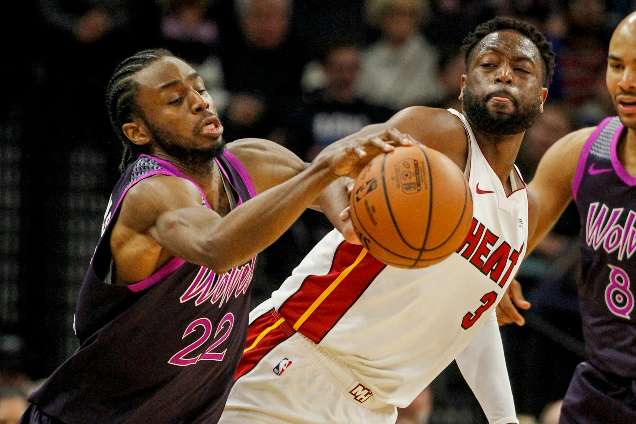 Minesota Timberwolves forward Andrew Wiggins struggles to control the ball as Miami guard Dwyane Wade defends in the third quarter