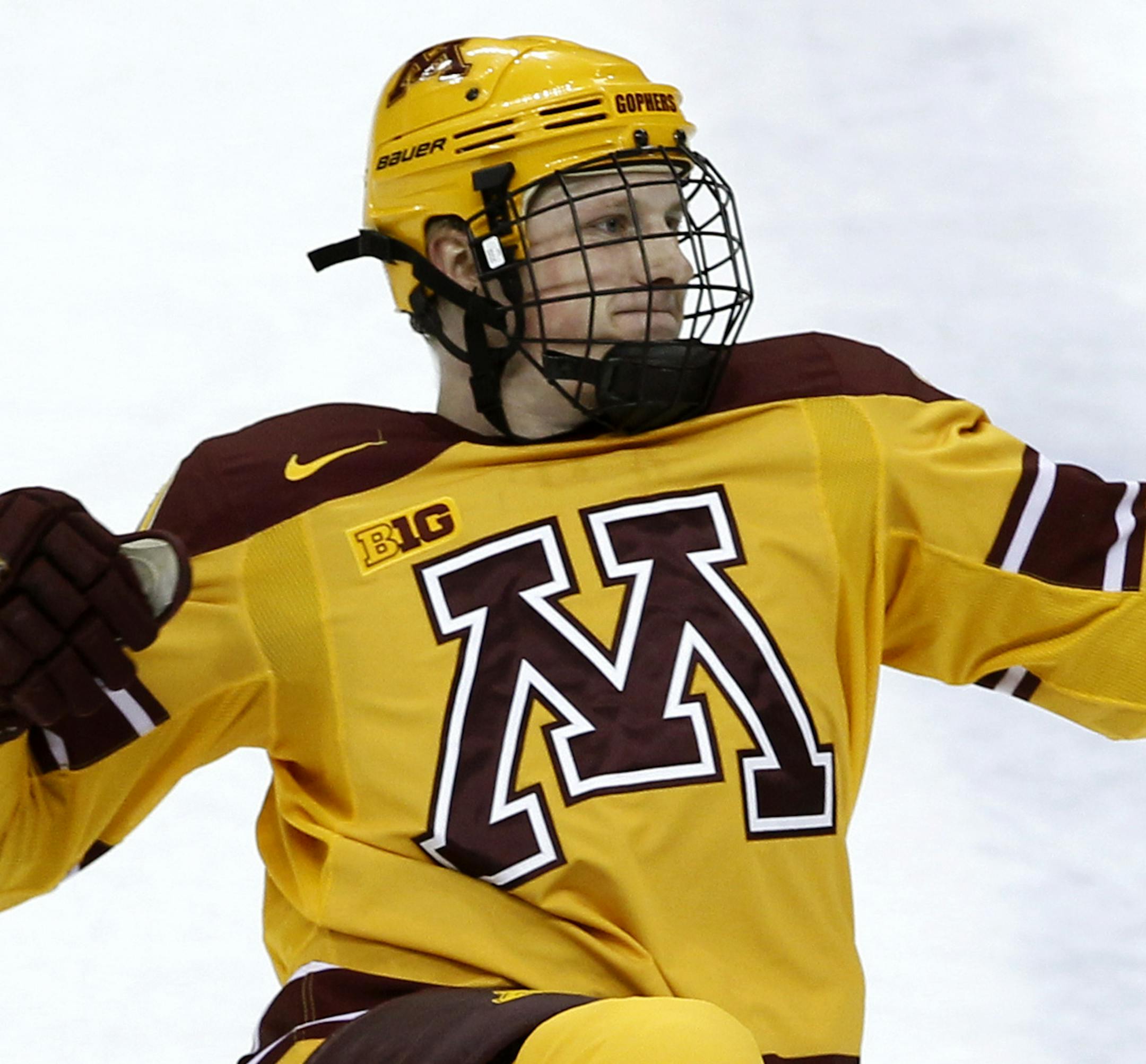 Minnesota defense Michael Brodzinski reacts after scoring on Robert Morris goalie Dalton Izyk during the first period of an NCAA West college regional hockey game in St. Paul, Minn., Saturday, March 29, 2014. (AP Photo/Ann Heisenfelt)