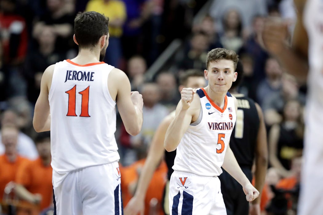 Virginia's Ty Jerome (11) and Kyle Guy