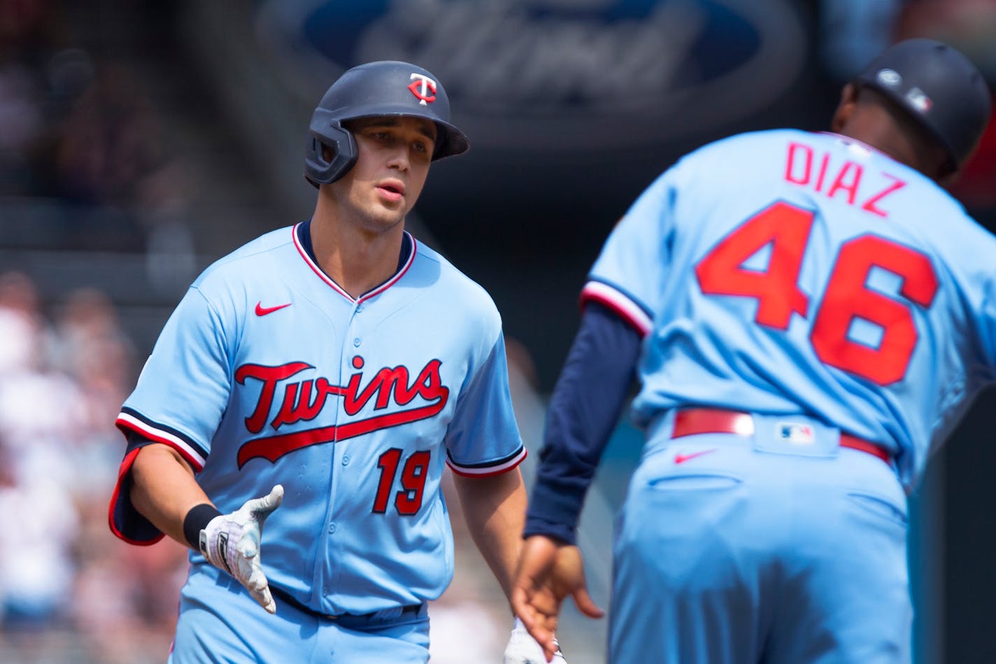 Alex Kirilloff is congratulated by third base coach Tony Diaz on his two-run home run against the Tigers during the sixth inning