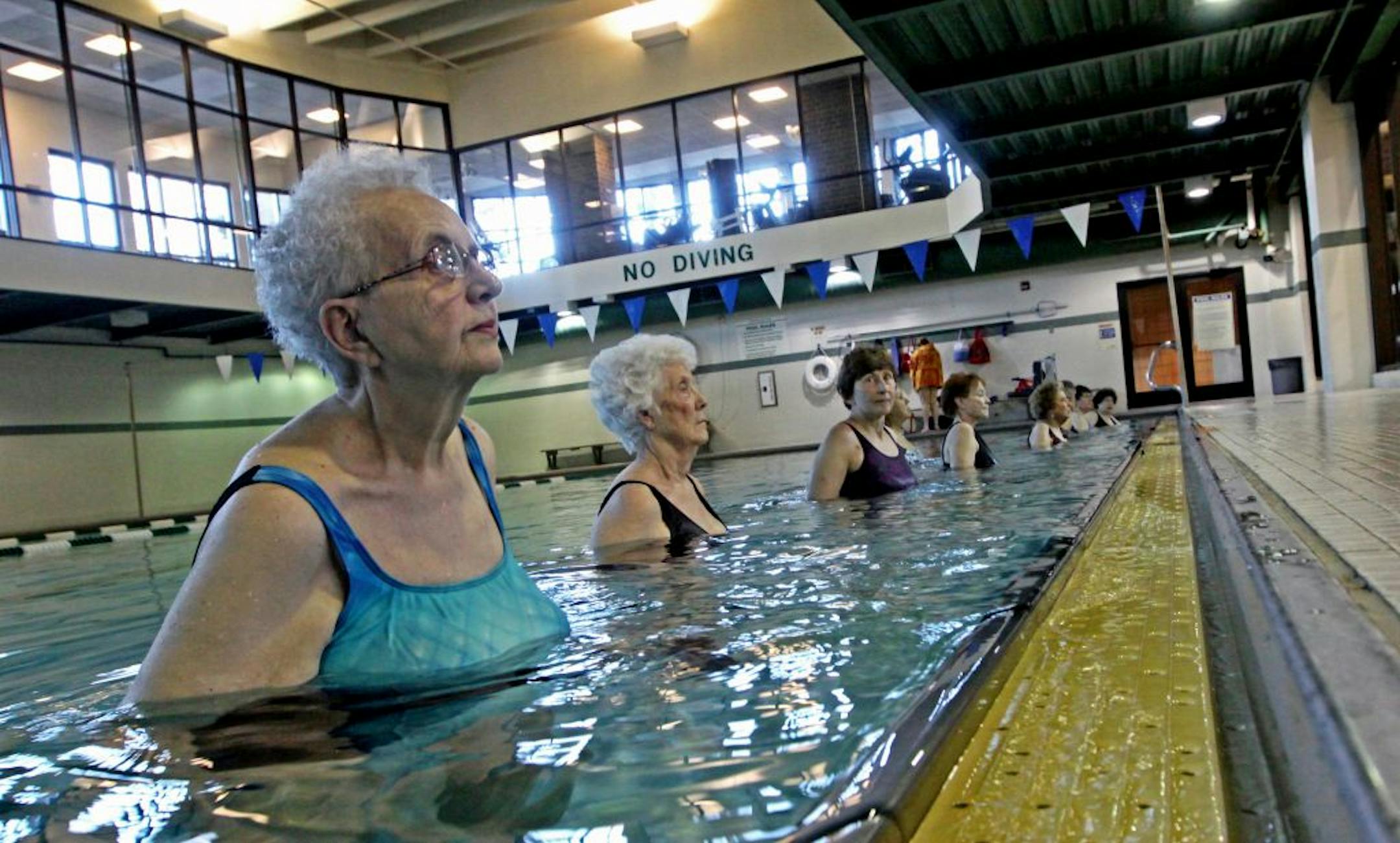 (left) Rita Acker and other seniors took part in the morning stretching and toning class at the Edinborough Park pool, as children and parents played in the play area next to the pool on 2/9/12. Seniors who live near Edinborough Park in Edina are pelting the City Council with letters protesting the possible elimination of the park's lap pool. Last month, a consultant suggested the city close the pool to update the facility. That's hasn't gone over well with seniors who live in the Edinborough co