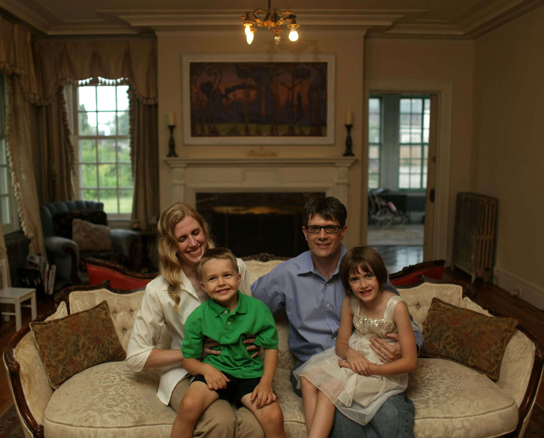 Alissa Pier, Lucian Pier, 4, Brent Pier, and Maeryn Pier, 6, sit for a portrait in their living room on Thursday afternoon. ] Architect/homeowner Alissa Pier used original 1920s blueprints to restore this home in north Minneapolis, after a tornado tore off its roof. MONICA HERNDON monica.herndon@startribune.com Minneapolis, MN 07/24/14