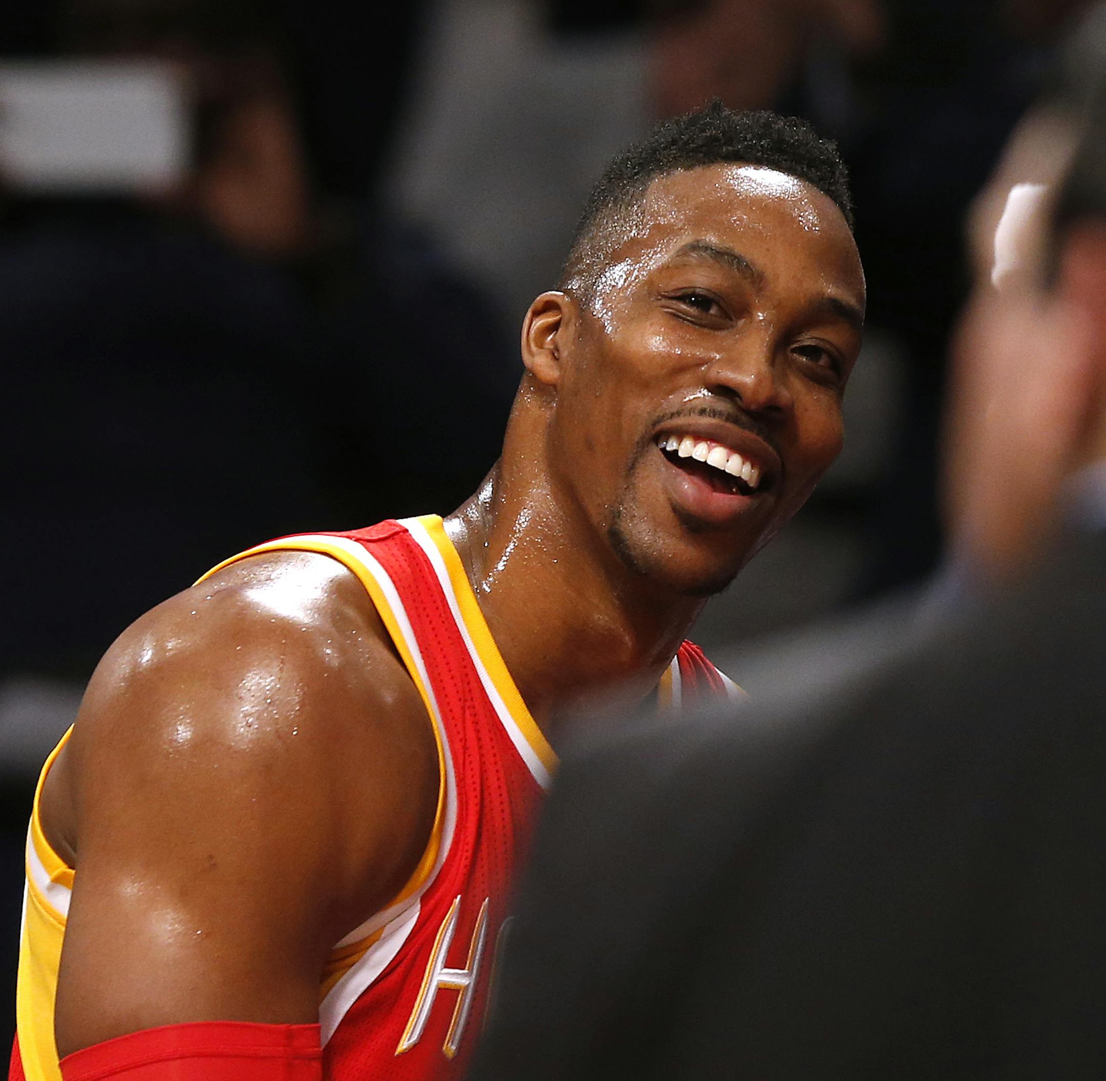 Houston Rockets' Dwight Howard (12) smiles on the sideline after an altercation with Brooklyn Nets' Kevin Garnett (2) during the first quarter of an NBA basketball game Monday, Jan. 12, 2015, in New York. Garnett was ejected from the game as a result of the incident. (AP Photo/Jason DeCrow)