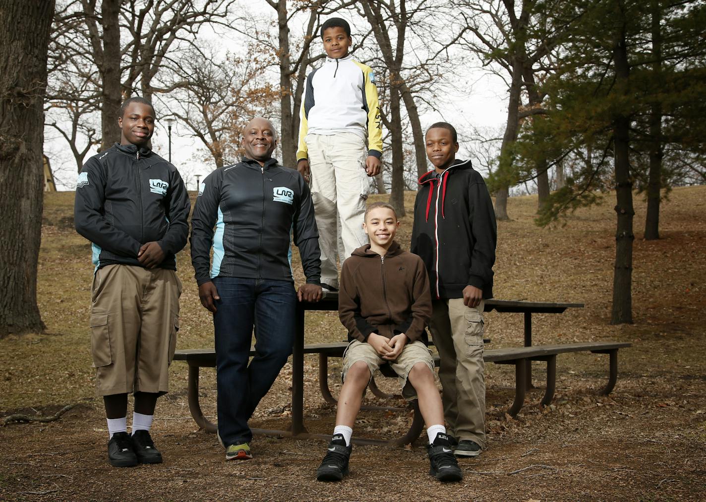 Anthony Taylor is the Adventures Director on The Loppet Foundation staff photographed with members of the Nellie Stone Johnson Community School Nordic ski and Mountain bike team at Theodore Wirth Park. Kids (L to R) Li'Tavius Munn, 14, Melvin Russell, 12, Donovan Blatcher, 12 and Kemari Williams, 13. ] CARLOS GONZALEZ cgonzalez@startribune.com, April 8, 2015, Minneapolis, MN, portrait of Anthony Taylor, who Adventures Director on the Loppet Foundation staff. His Major Taylor Cycling Club promote