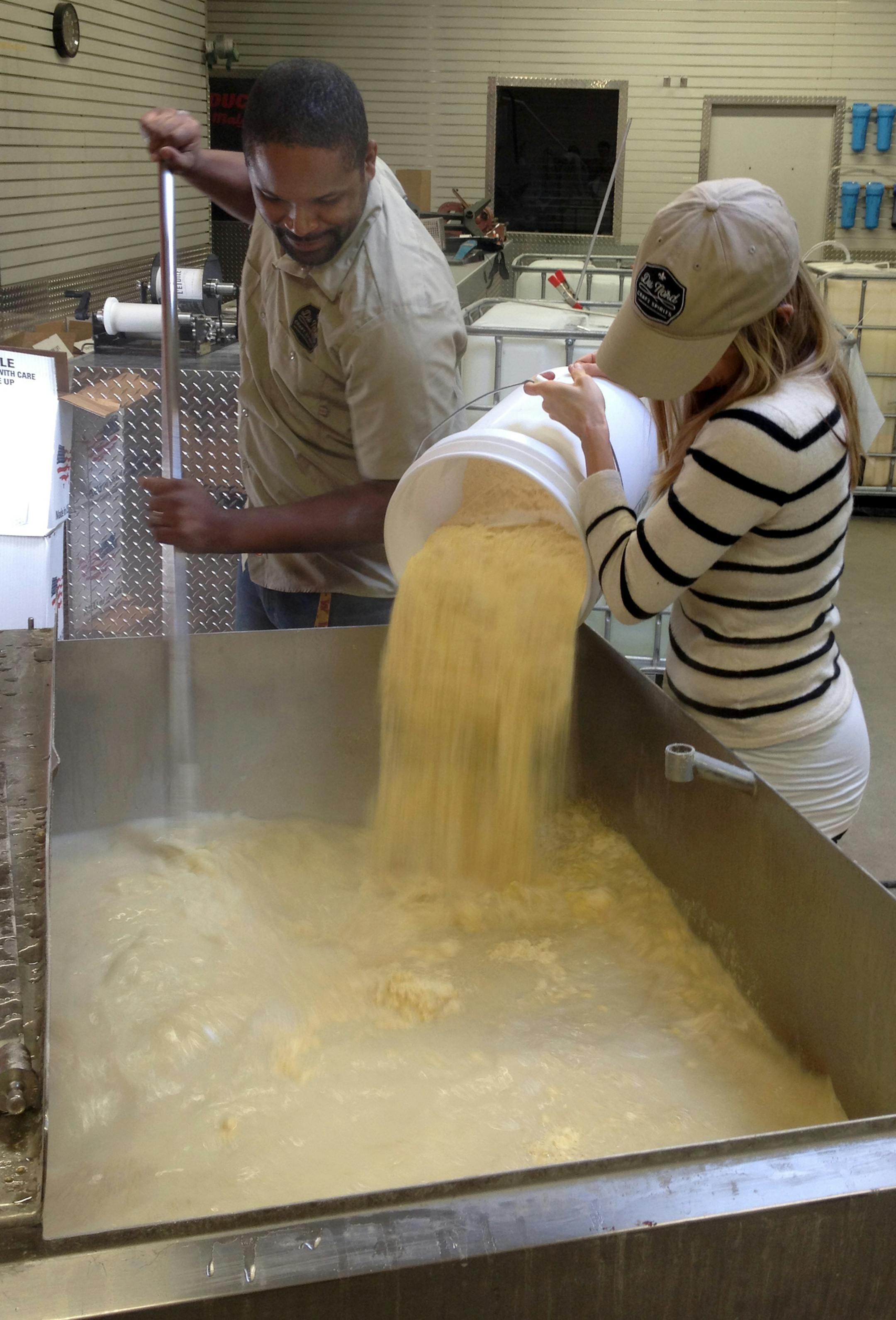 Chris (left) and Shanelle Montana of Du Nord Craft Spirits stir corn into a vodka mash at their south Minneapolis distillery. Du Nord Craft Spirits