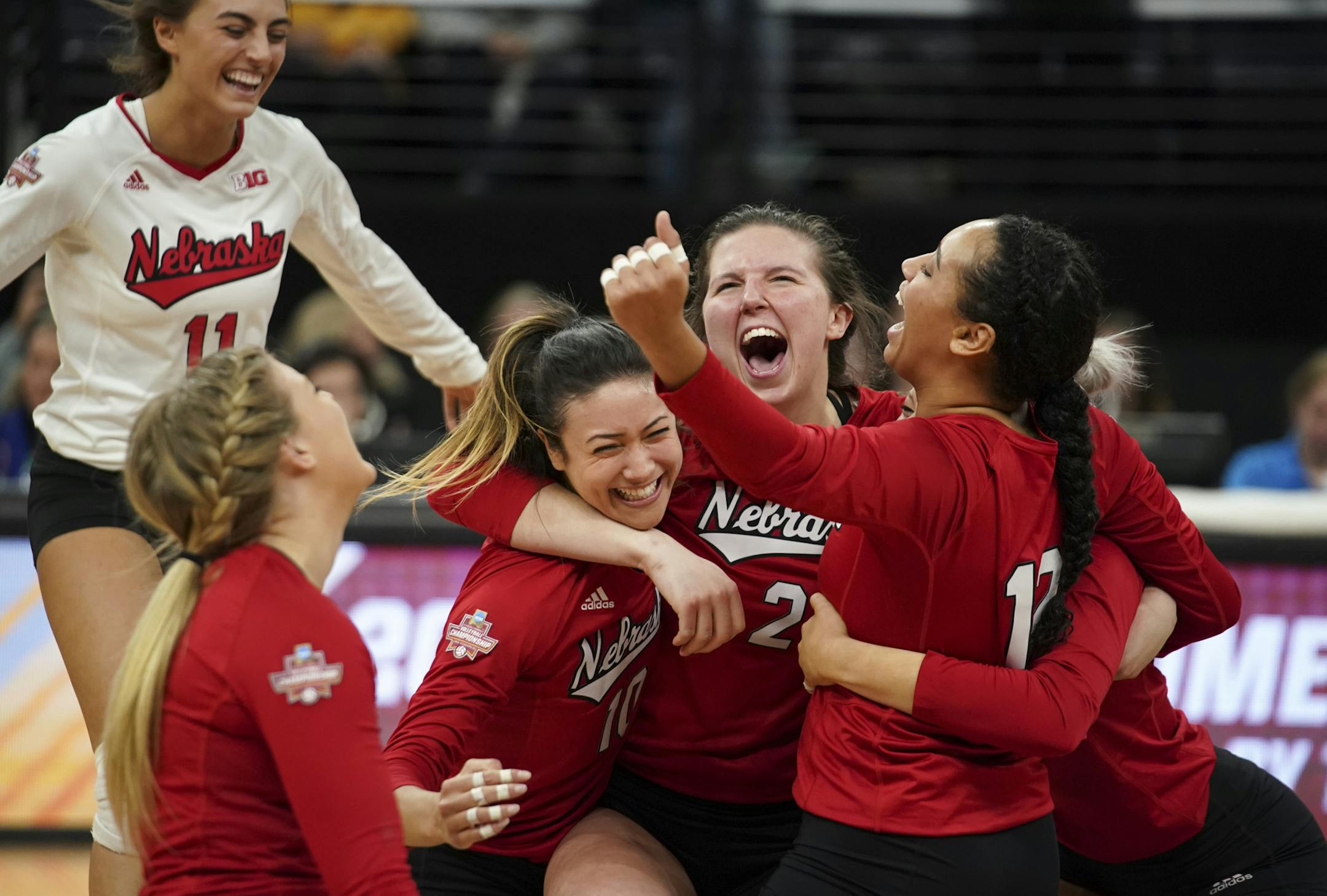 Nebraska's Mikaela Foecke (2) celebrated her set-winning shot Thursday night with teammates. The Cornhuskers now will play for the national championship. ] JEFF WHEELER ï jeff.wheeler@startribune.com Nebraska won three straight sets to defeat Illinois 3-2 in their NCAA Women's Volleyball Championship Semifinal Thursday evening, December 13, 2018 at Target Center in Minneapolis.