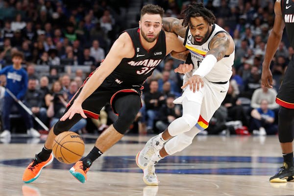 Timberwolves guard D’Angelo Russell, right, guarded Miami’s Max Strus on Monday. Russell had 12 assists Wednesday in a win over the Pacers and Min