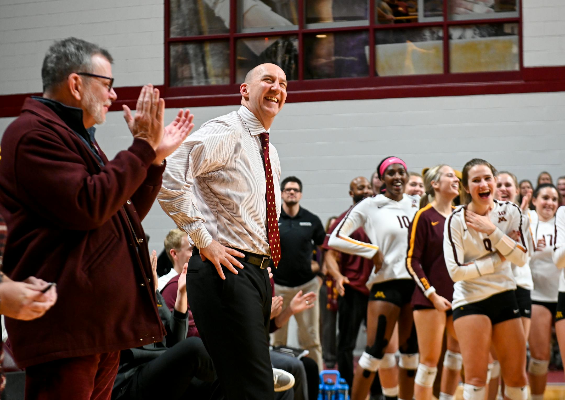 Gophers head coach Hugh McCutcheon stood beside his team and University president Eric Kaler, left, as he was recognized for his induction into the International Volleyball Hall of Fame.