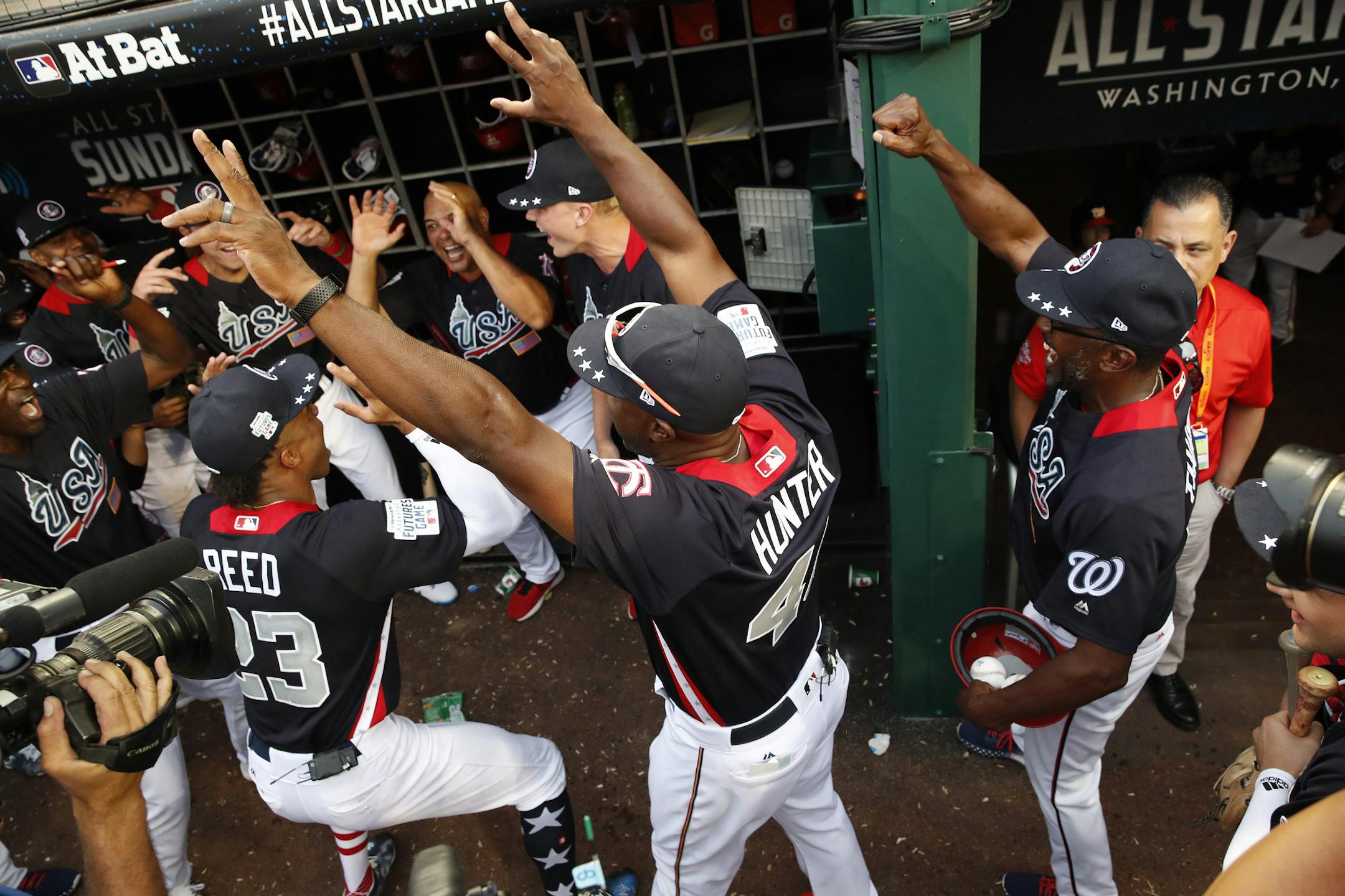 U.S. Team Manager Torii Hunter celebrates with his team after the All-Star Futures baseball game against the World Team , Sunday, July 15, 2018, at Nationals Park, in Washington. The the 89th MLB baseball All-Star Game will be played Tuesday. The U.S. won 10-6. (AP Photo/Alex Brandon)